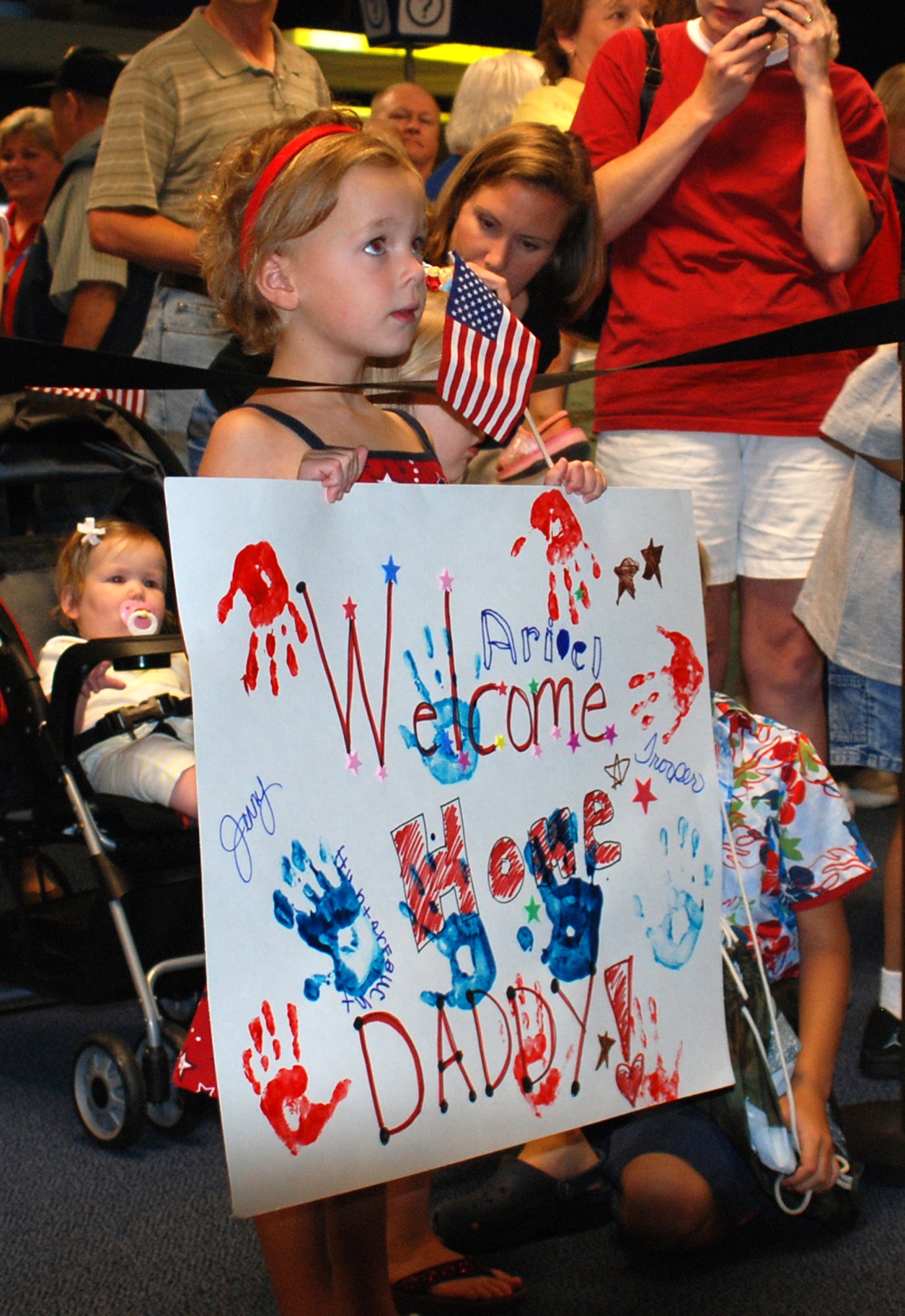 301st Fighter Wing family members await the arrival of their loved ones at the Dallas/Fort Worth International Airport upon the conclusion of a deployment to Balad Air Base, Iraq.  Nearly 200 Air Force Reservists from the 301st Fighter Wing out of the Naval Air Station Joint Reserve Base Fort Worth, Texas, deployed in support of Operation Iraqi Freedom. this Spring. (U.S. Air Force Photo/Laura Dermarderosian-Smith)
