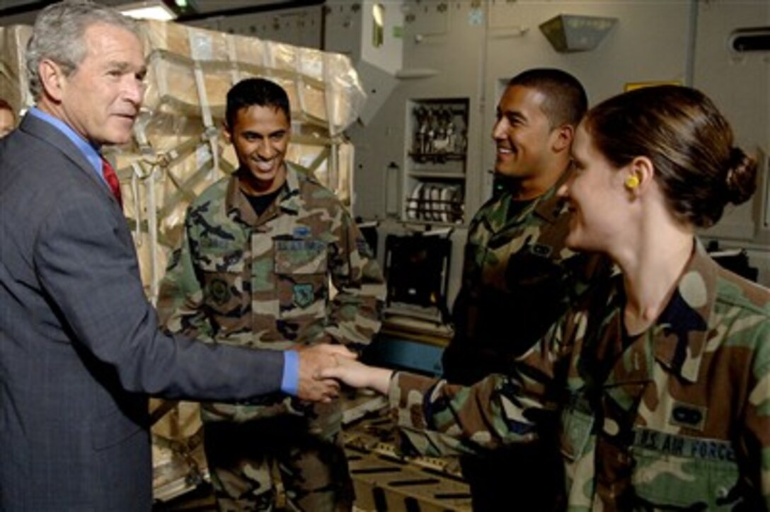 President George Bush shakes hands with Senior Airman Shannon Jones, 437th Aerial Port Squadron cargo processor, in a C-17 Globemaster III at Charleston Air Force Base, S.C., July 24, 2007. 