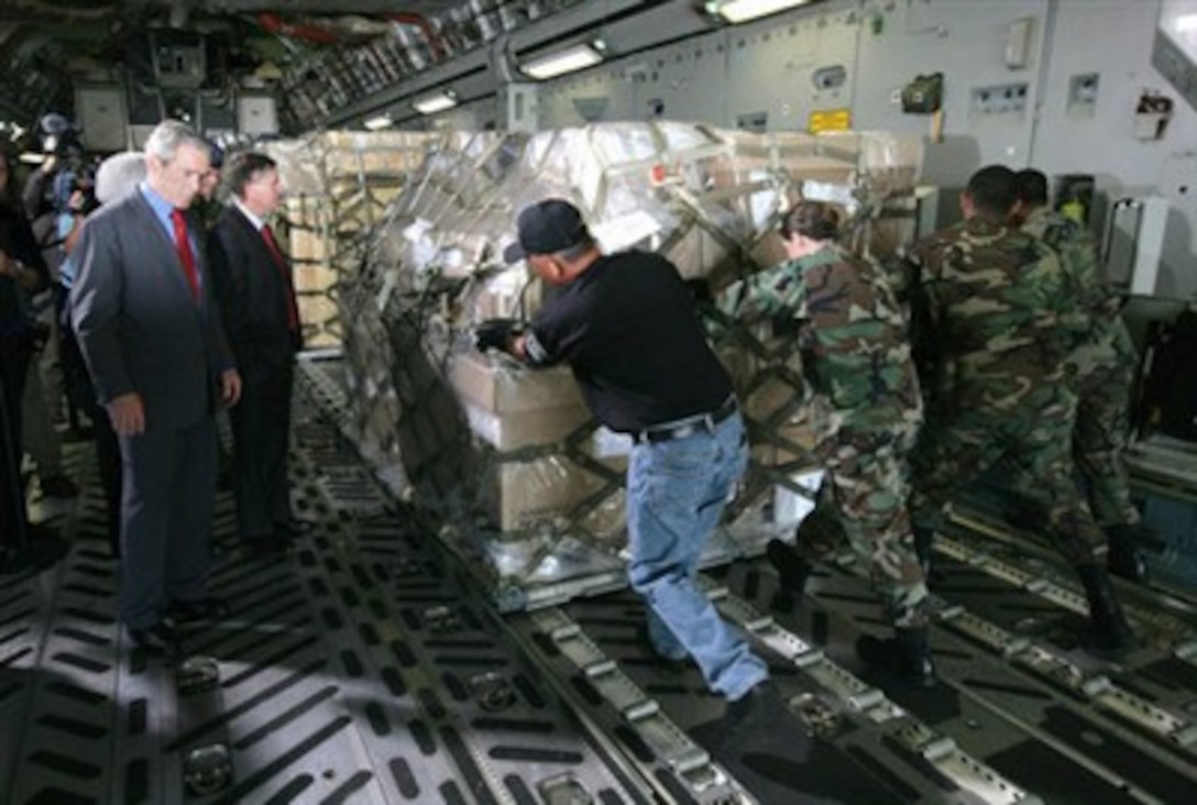 President George W. Bush, joined by South Carolina Sen. Lindsey Graham, watches as U.S. Air Force personnel conduct cargo loading operations aboard a C-17 aircraft,  July 24, 2007, during a visit to Charleston Air Force Base, S.C.  