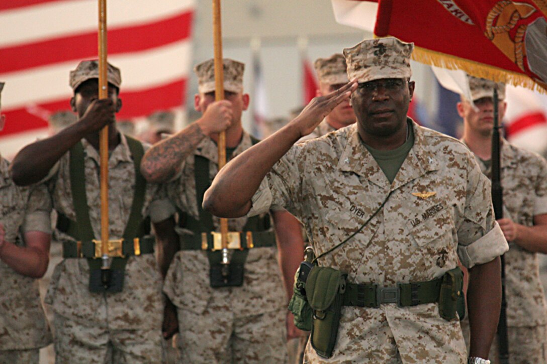 Col. Michael A. Dyer, former Marine Corps Air Station Iwakuni commanding officer and native of Trinidad and Tobago, West Indies, renders a salute during the change of command ceremony on the flight line here July 25.