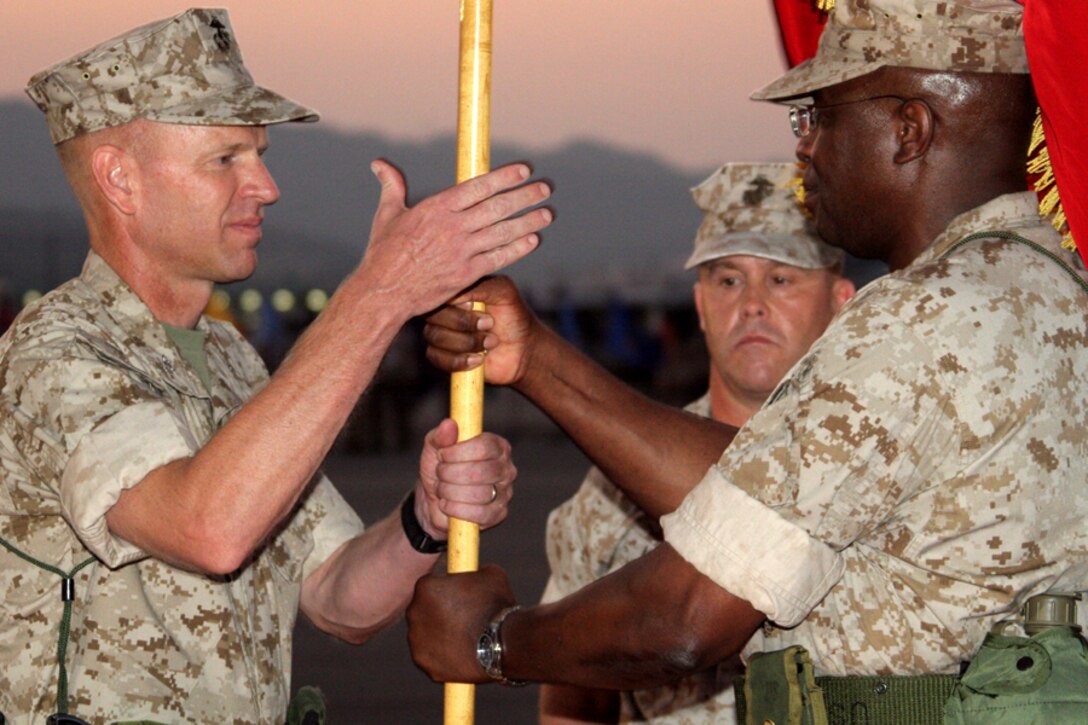 Col. Michael A. O?Halloran, Marine Corps Air Station Iwakuni commanding officer and State College, Pa., native, receives the guidon from Col. Michael A. Dyer, former commanding officer and native of Trinidad and Tobago, West Indies, during a change of command ceremony on the flight line here July 25.