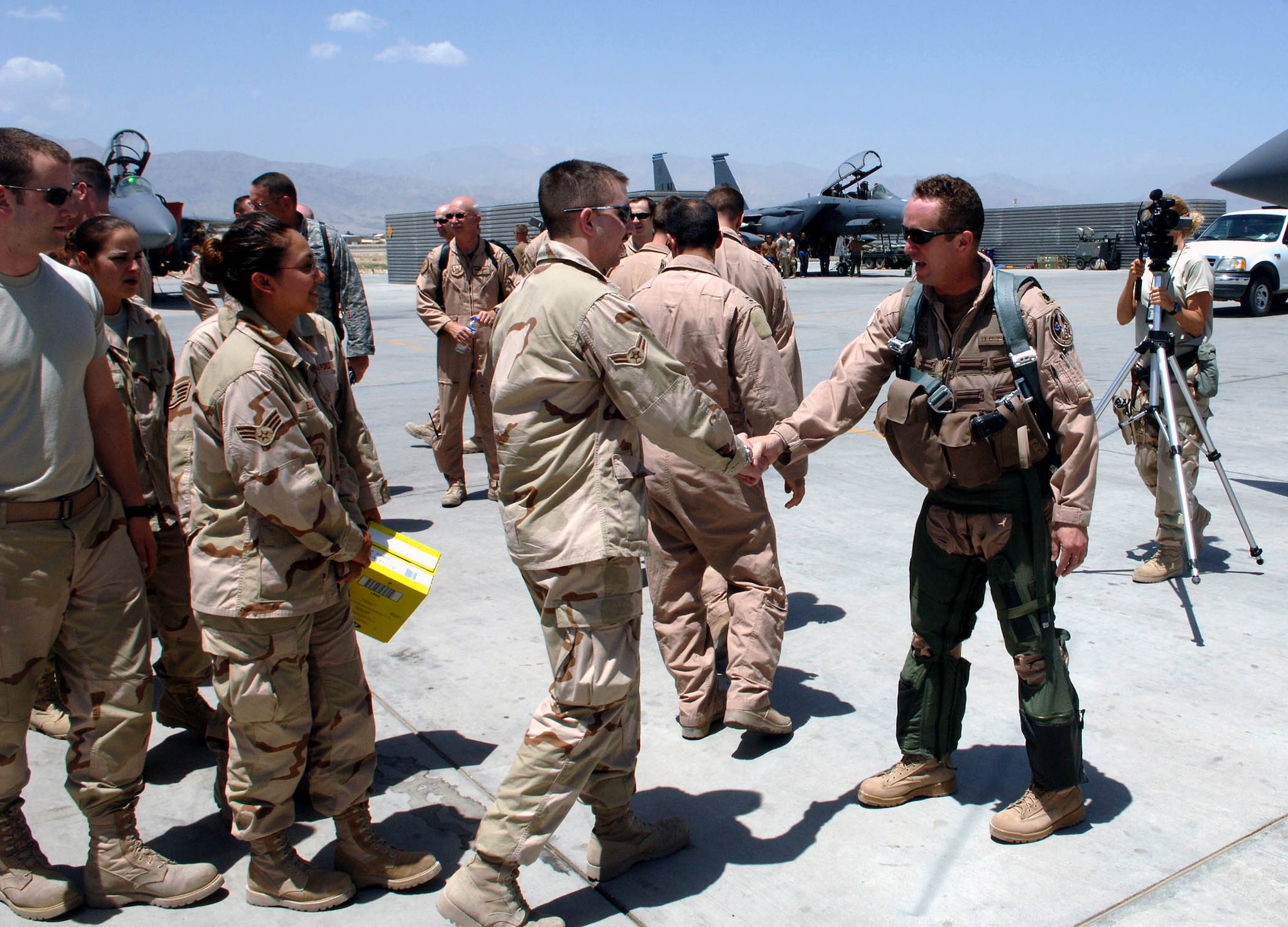 Lt. Col. Dave Iverson (right), 492nd Expedtionary Fighter Squadron, is congratulated by fellow squadron members upon his completion of more than 3,000 flight hours in the F-15E Strike Eagle July 25 at Bagram Airfield, Afghanistan. Col. Iverson is only the 15th pilot to cross this milestone in the F-15E and is deployed from RAF Lakenheath. (U.S. Air Force photo by Staff Sgt. Craig Seals)