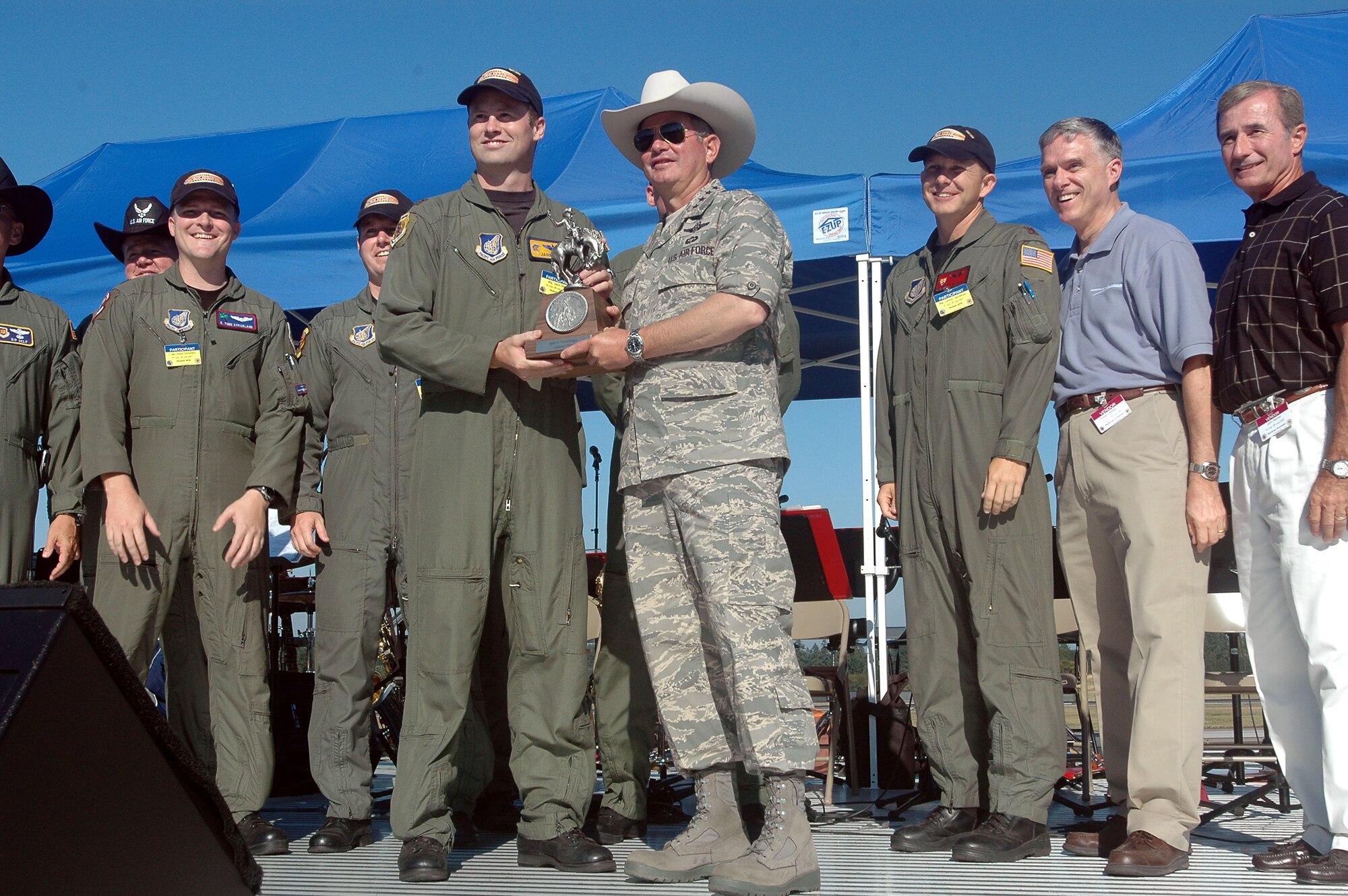 Gen. Duncan J. McNabb, Air Mobility Command commander, hands the Assault Landing Award to Maj. Jason Mills, lead pilot for Team Hickam.  