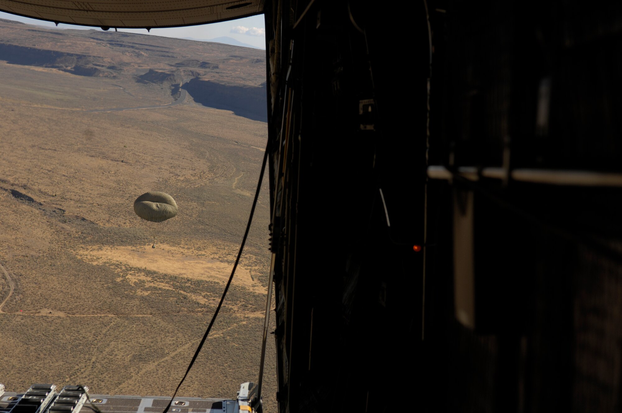 A pallet falls out of a C-130 Hercules during an air cargo drop during a flight from McChord Air Force Base, Wash., July 24, 2007, during Air Mobility Rodeo 2007. Air Mobility Command's Rodeo 2007 is a readiness competition of U.S. and international mobility air forces.  It focuses on improving war fighting capabilities and support of the Global War on Terrorism. (U.S. Air Force photo by Senior Airman Patrick J Dixon) 