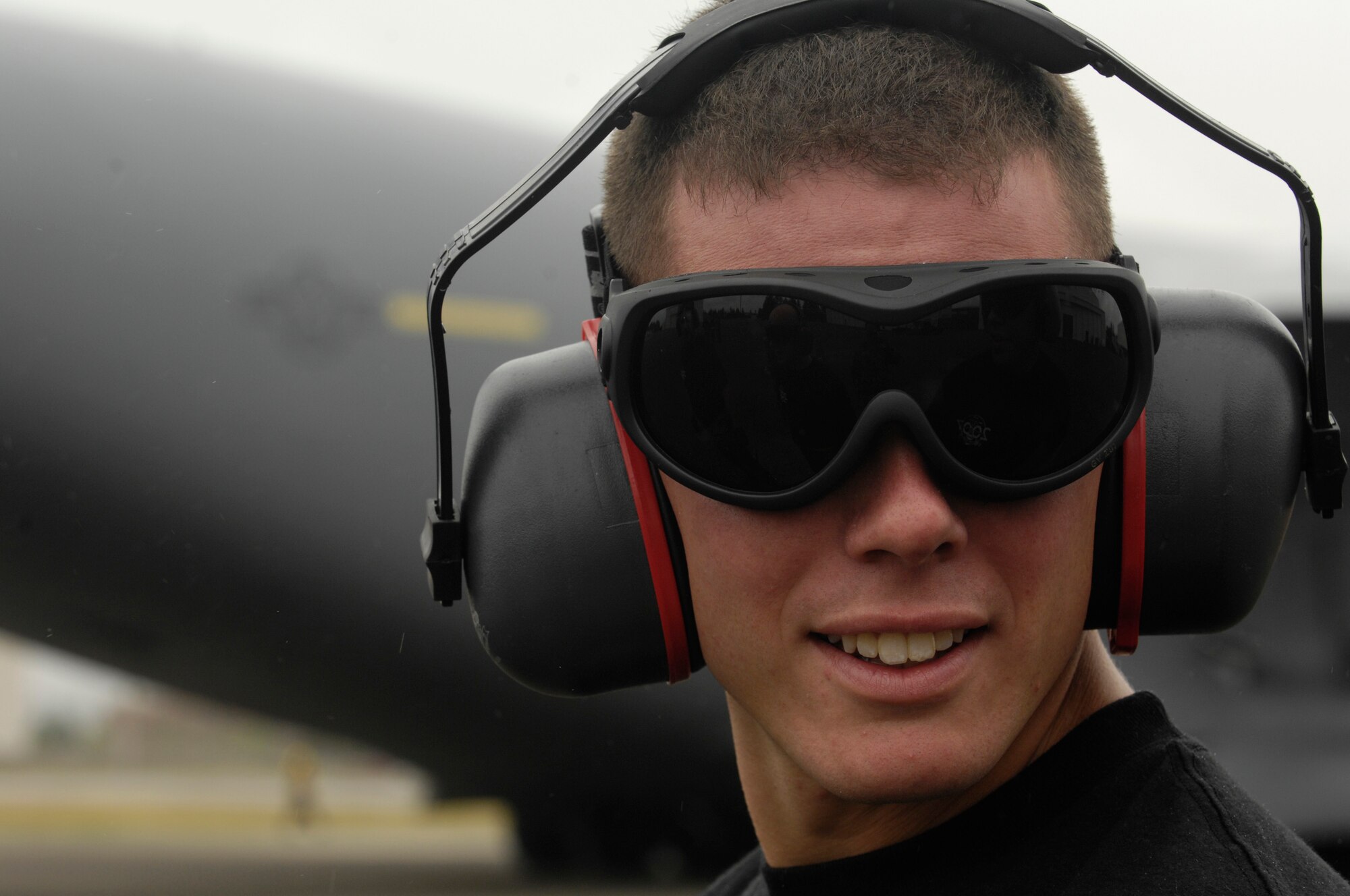 Senior Airman Stuart Simpson, 437th Airlift Wing, Charleston Air Force Base, S.C., looks over at his teammates during the aerial port engine running on-load competition for Air Mobility Rodeo 2007 at McChord AFB, Wash., July 23. Rodeo 2007 is a readiness competition of U.S. and international mobility air forces. It focuses on improving warfighting capabilities and support of the Global War on Terrorism.  (U.S. Air Force Photo/Airman 1st Class Nichelle Griffiths) 
