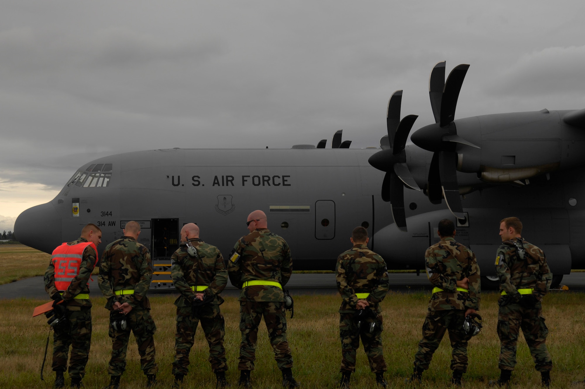 Airmen from the 314th Air Maintenance Squdron, Little Rock Air Force Base, Ark., wait for a debrief outside their C-130J at McChord AFB, Wash., July 23 during Air Mobility Rodeo 2007. Air Mobility Command's Rodeo 2007 is a readiness competition of U.S. and international mobility air forces.  It focuses on improving war fighting capabilities and support of the Global War on Terrorism. (U.S. Air Force Photo/Senior Airman Patrick J Dixon)


