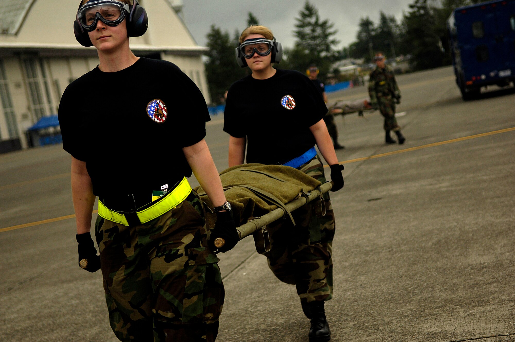 Airmen carry mock patients on litters to waiting members of the 375th Aeromedical Evacuation Squadron from Scott Air Force Base, Ill., aboard a C-130 Hercules July 23 at McChord Air Force Base, Wash. The scenario was part of the aeromedical evacuation competition during Air Mobility Command's Rodeo 2007, a readiness competition of U.S. and international mobility air forces. (U.S. Air Force photo/Tech. Sgt. Jeremy T. Lock)

