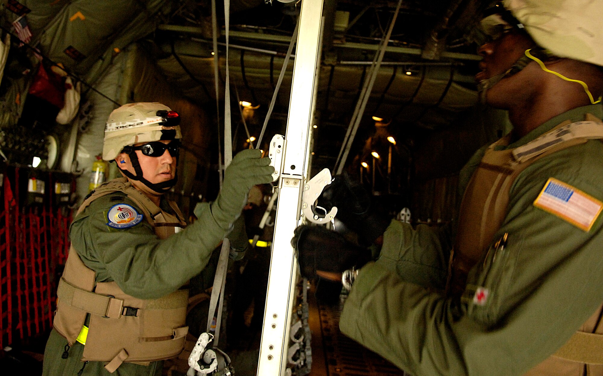 Capt. John Camacho-Ayala and Tech. Sgt. Kermit McLauchin configure a C-130 Hercules during a aeromedical evacuation competition July 23 for Air Mobility Command's Rodeo 2007 at McChord Air Force Base, Wash. Captain Camacho-Ayala is a flight nurse and Sergeant McLauchin is a medical technician with the 375th Aeromedical Evacuation Squadron at Scott AFB, Ill. (U.S. Air Force photo/Tech. Sgt. Jeremy T. Lock)
