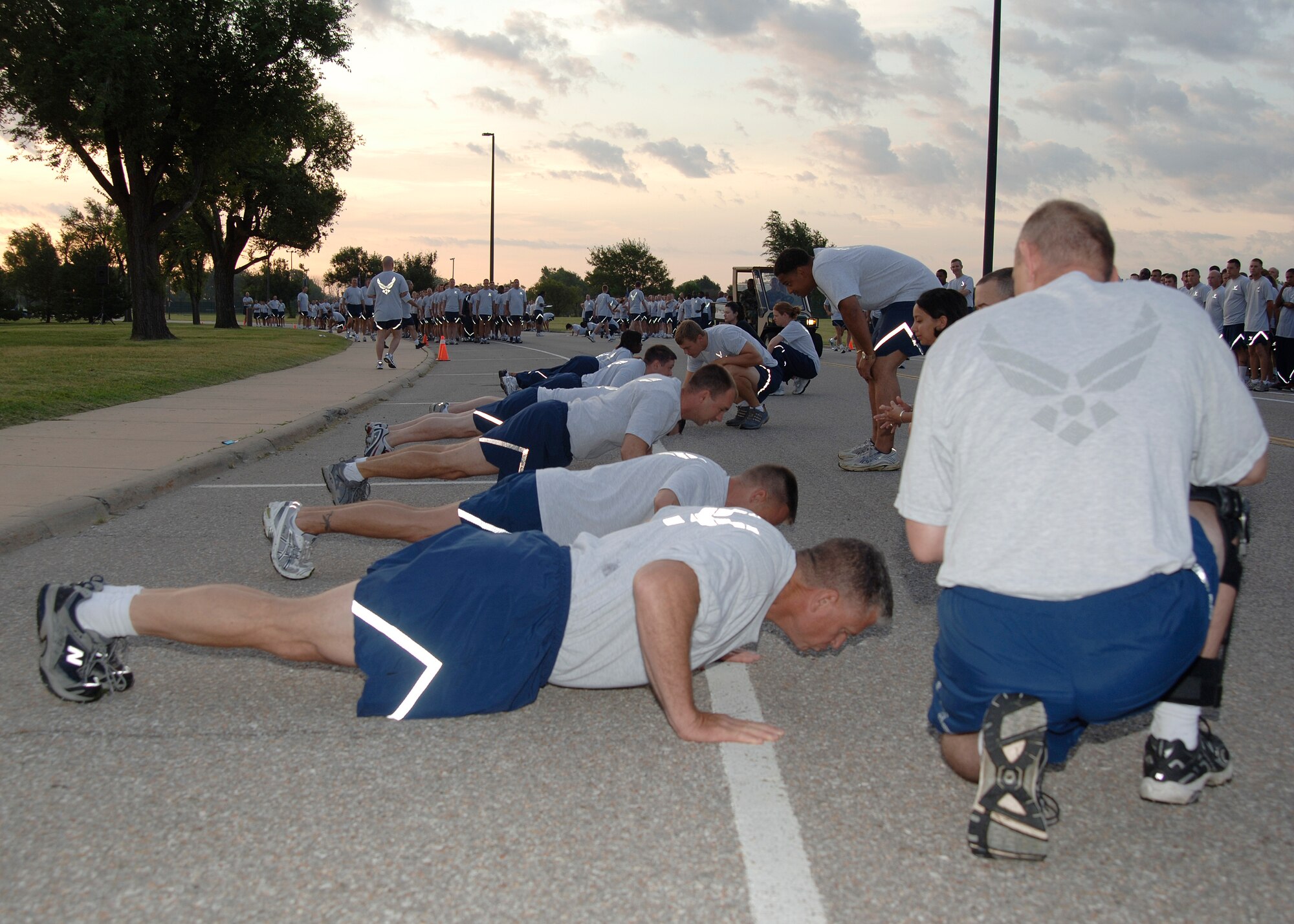 MCCONNELL AIR FORCE BASE, Kan. -- Team McConnell members compete in a base-wide push-up contest here July 20. The contest was held to raise money for the upcoming McConnell Air Force Ball in September. The top male performer in the 30-plus category was Master Sgt. James Richardson, 22nd Mission Support Squadron first sergeant. The top female performer in the same category was Lt. Col. Nancy Bozzer, 348th Air Refueling Squadron. The top male performer in the under 30 category was Senior Airman Michael Kraus, 22nd Comptroller Squadron, and the top female performer in the same category was Senior Airman Sharnai Skinner-Woodruff, 349th Air Refueling Squadron. (Photo by Airman 1st Class Jessica Corob)