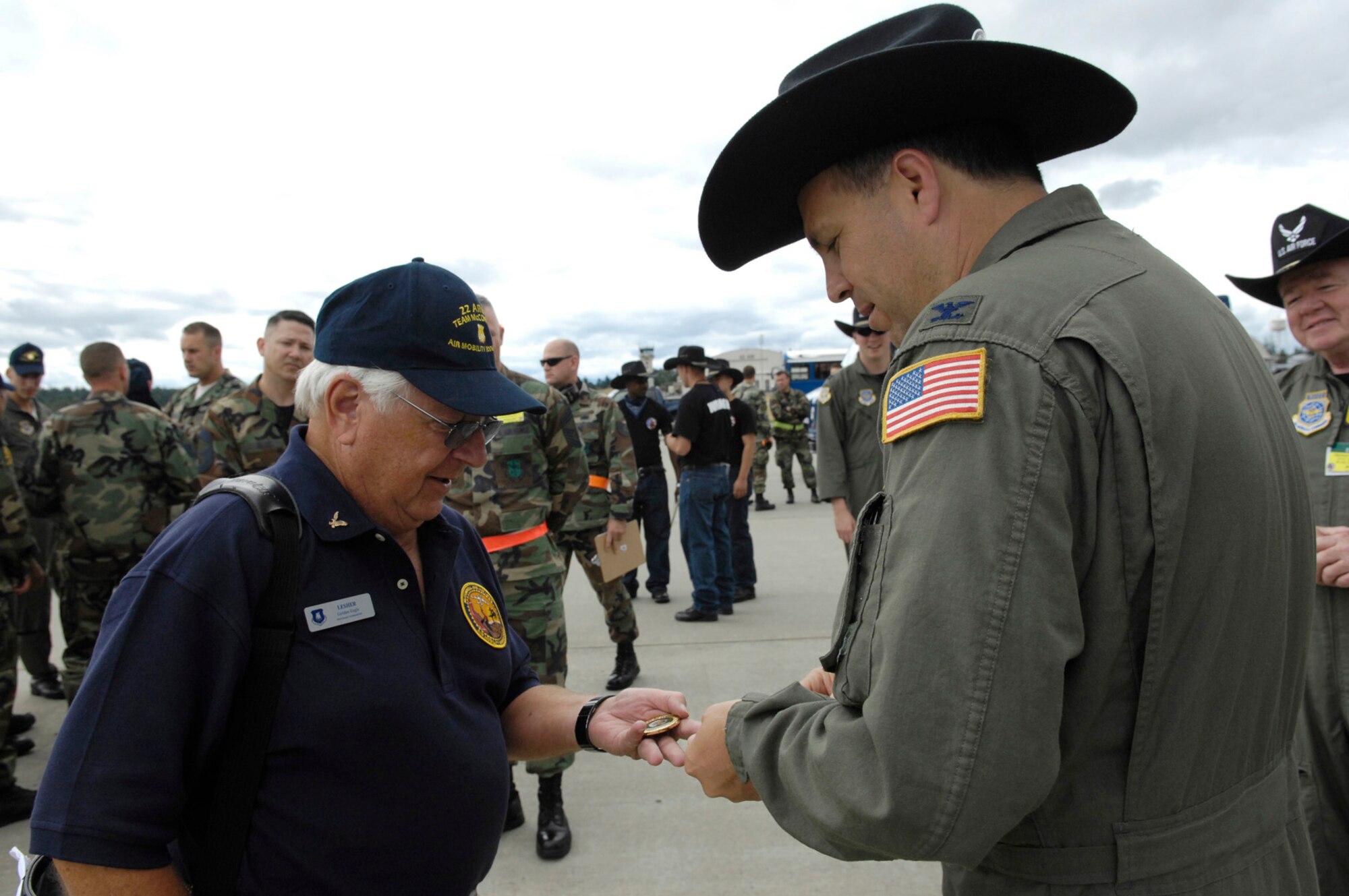 MCCHORD AIR FORCE BASE, Wash. -- Col. Jerry Martinez, 62nd Air Lift Wing commander, McChord, gives a coin to Mr. Keith Lesher, president of the Friends of McConnell, July 21, during this year’s Rodeo competition at McChord. Rodeo 2007, hosted by Air Mobility Command, is a readiness competition of U.S. and international mobility forces. It focuses on improving warfighting capabilities and support of the Global War on Terrorism. (Photo by Airman 1st Class Bryan Boyette)(Released)