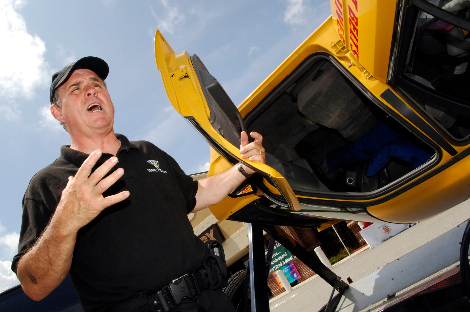 HANSCOM AFB, Mass. -- Sgt. Mike Crosby, Massachusetts State Police traffic division, explains the effects of not wearing a safety belt during a demonstration in the BX parking lot. (U.S. Air Force photo by Mark Wyatt)