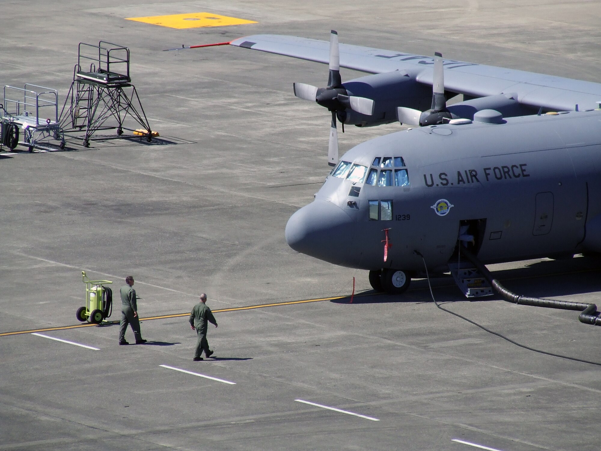 Aircrew members walk out to a C-130 Hercules prior to a competition mission for Air Mobility Rodeo 2007 at McChord Air Force Base, Wash., July 25.  Rodeo, sponsored by Air Mobility Command, is a readiness competition for U.S. and international mobility air forces.  Rodeo 2007 has the largest international team representation in its history and is overall the largest Rodeo competition ever completed.  (U.S. Air Force Photo/Tech. Sgt. Scott T. Sturkol)