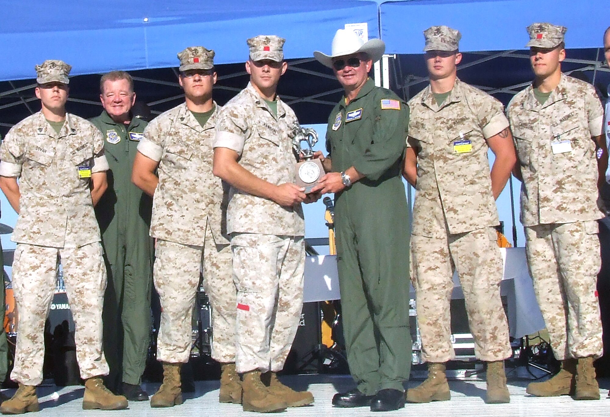 Gen. Duncan McNabb, Air Mobility Command commander, presents the Best Joint Inspection Team Award to Marines from the 2nd Marine Expeditionary Force, Marine Corps Air Station Cherry Point, N.C., during an awards presentation for Air Mobility Rodeo 2007 at McChord Air Force Base, Wash., July 25.  The Marines were one of 11 recipients of more than 60 awards that will be presented during the competition.  Rodeo, sponsored by Air Mobility Command, is a readiness competition for U.S. and international mobility air forces.  (U.S. Air Force Photo/Tech. Sgt. Scott T. Sturkol) 