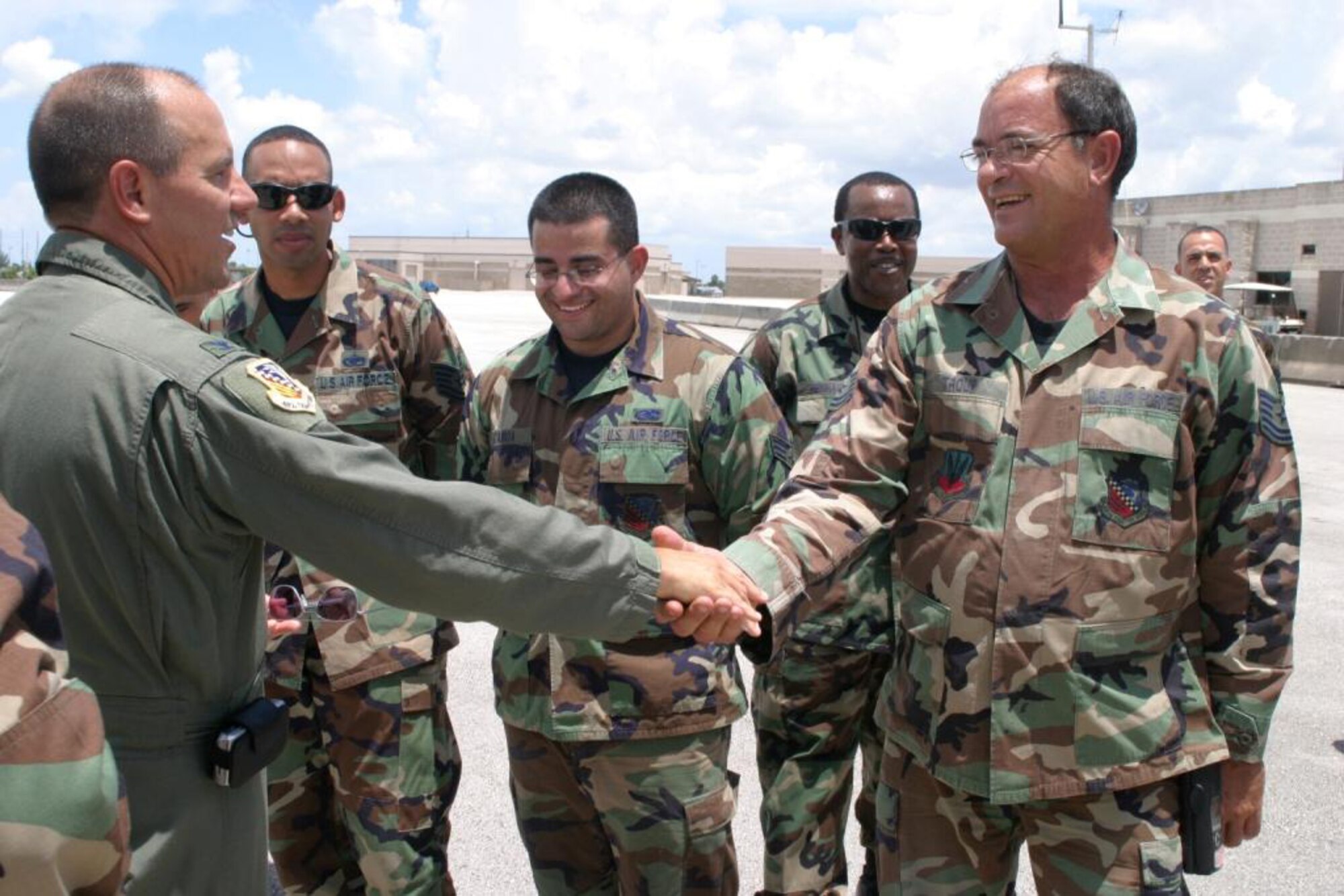 Col. Randy Falcon thanks Tech. Sgt. Terry Troup, an egress systems maintainer, and fellow Maintenance Group Airmen for their hard work in refurbishing the Wing flagship. The 482nd FW commander lauded their efforts for “making aircraft 290 look better than the day it left the factory.” Airmen presented the commander with a pristine jet here July 15 after a flawless repainting and meticulous cleaning. Each Air Force wing commander of a flying unit is authorized an aircraft designated as the flagship, or commander’s plane. (U.S. Air Force photo/Tech. Sgt. Paul Dean)