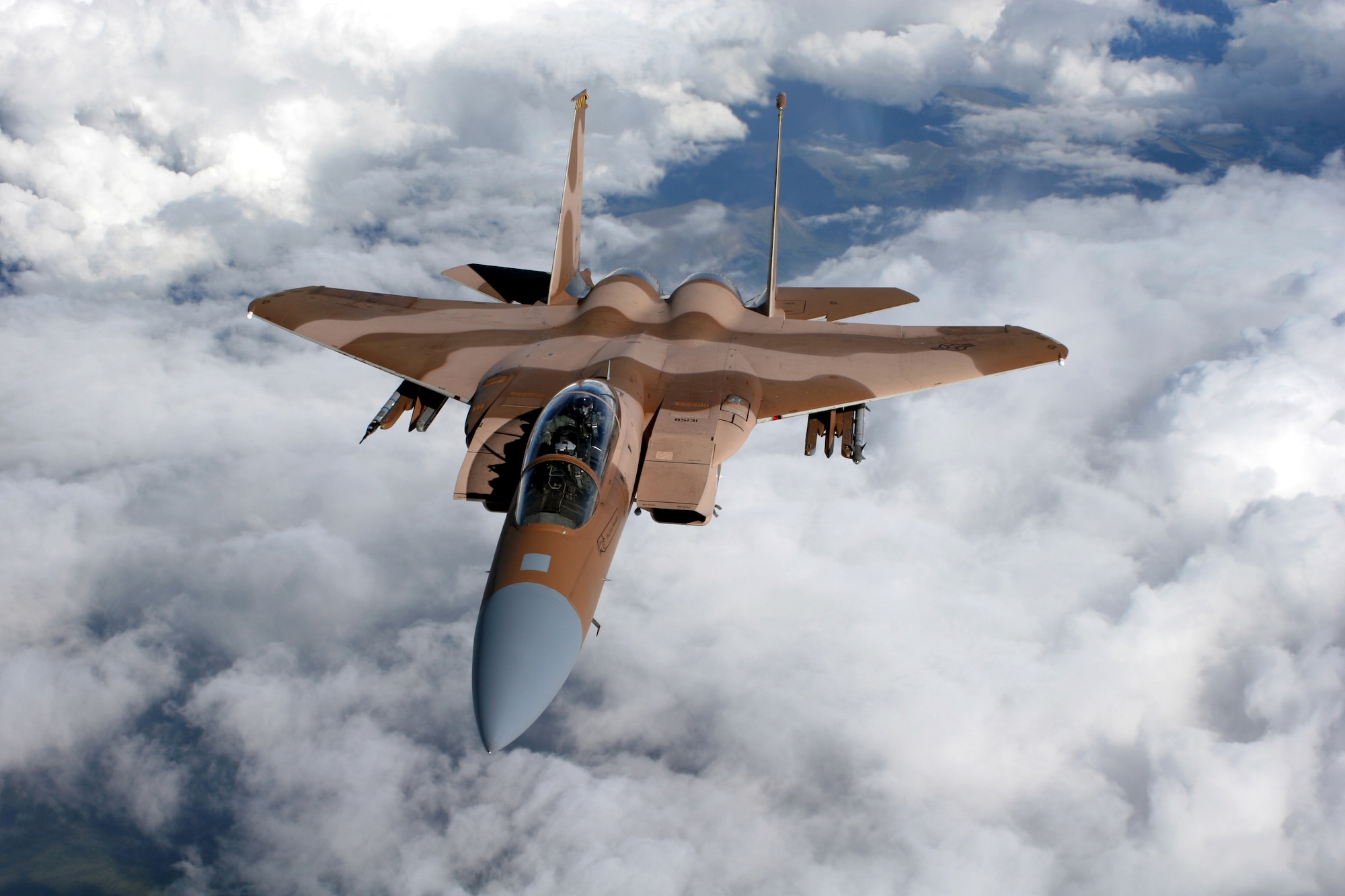 EIELSON AIR FORCE BASE, Alaska -- An F-15C Aggressor from 65th Aggressor Squadron, Nellis Air Force Base, Nev., flies over a  mountain range on a refueling mission at Red Flag - Alaska July 25. Red Flag - Alaska enables aviation units to sharpen their combat skills by flying simulated combat sorties in a realistic threat environment. More than 80 aircraft and 1500 servicemembers from 6 different countries are participating in the exercise over the Last Frontier July 12-27.   (U.S. Air Force photo by Capt Tana Stevenson)