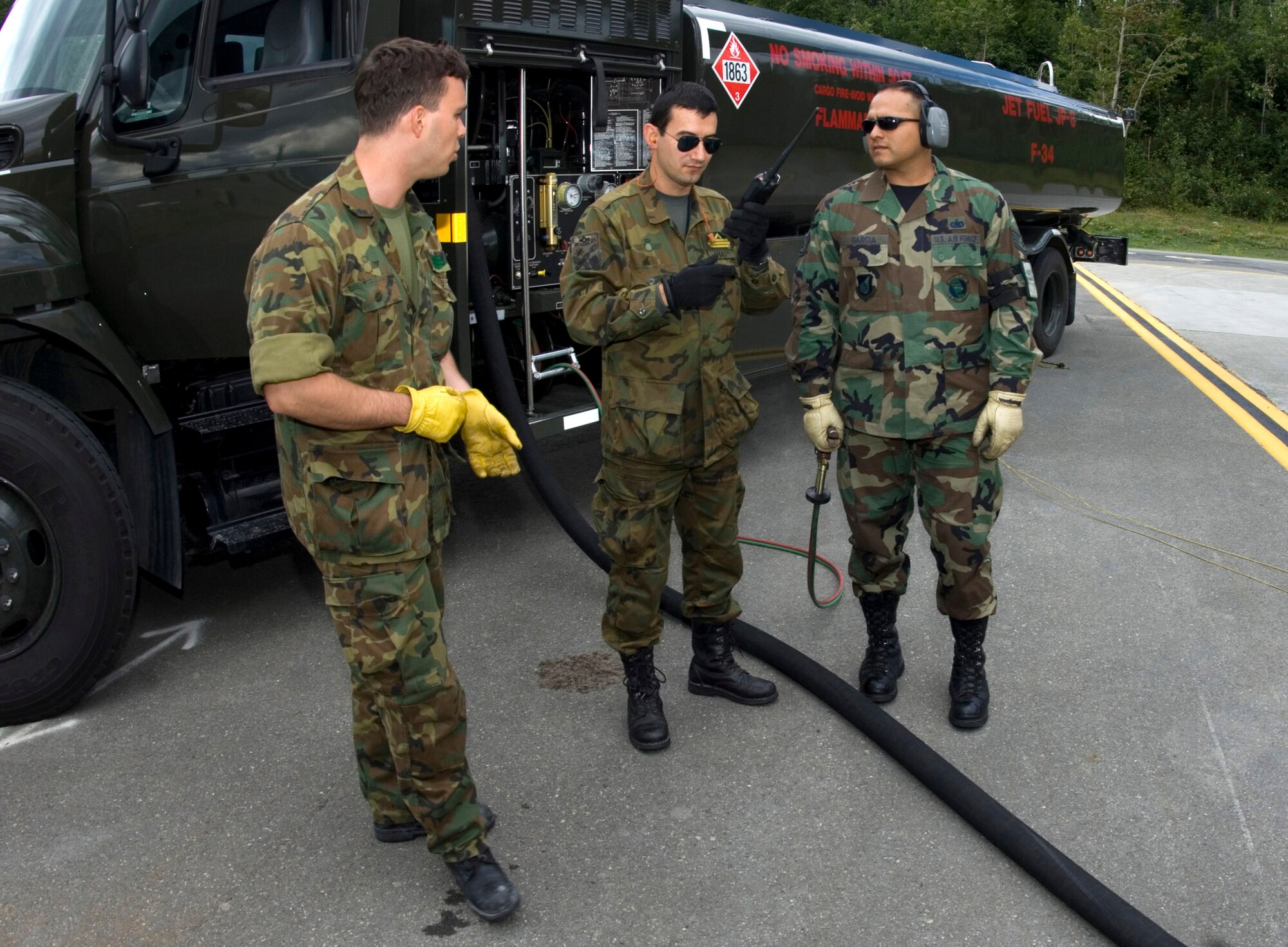 Spanish air force Senior Airman Jesus Utrilla and Master Sgt. Jose Arias work with Staff Sgt. Carlos Garcia while fueling a C-130 from Spain July 23 at Elmendorf Air Force Base, Alaska. Sergeant Garcia, assigned to the 3rd Logistics Readiness Squadron, is an Air Force liaison to the Spanish air force and is working with them during Red Flag-Alaska. More than 80 aircraft and 1,500 servicemembers from the six countries are flying together in this multinational exercise that provides realistic combat training in a safe and controlled setting over the Pacific Alaskan Range Complex and Eielson AFB, Alaska. (U.S. Air Force photo/Senior Airman Garrett Hothan)