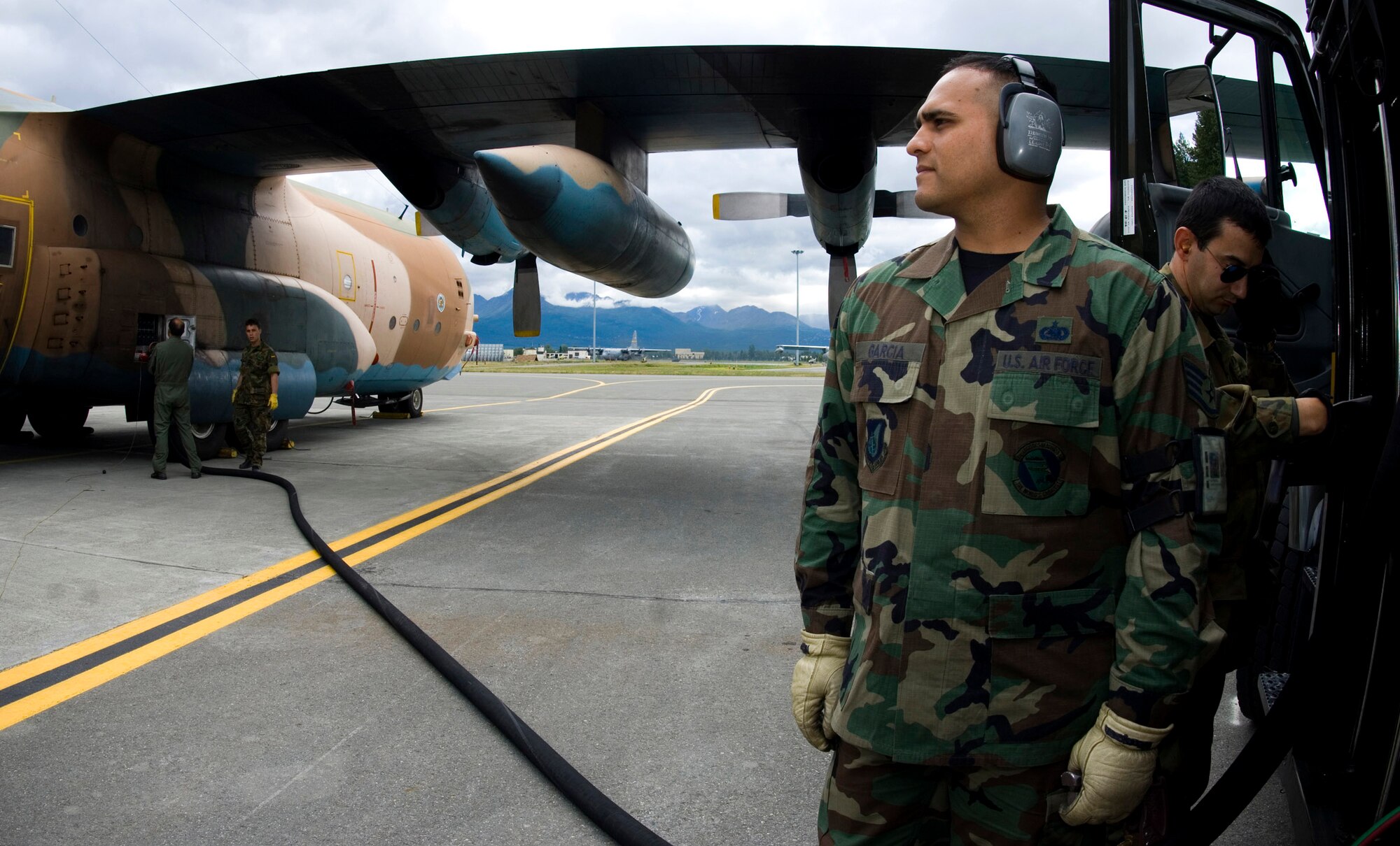 Staff Sgt. Carlos Garcia helps fuel a C-130 from Spain during Red Flag-Alaska July 23 at Elmendorf Air Force Base, Alaska. Sergeant Garcia, assigned to the 3rd Logistics Readiness Squadron, is an Air Force liaison to the Spanish air force. More than 80 aircraft and 1,500 servicemembers from the six countries are flying together in this multinational exercise that provides realistic combat training in a safe and controlled setting over the Pacific Alaskan Range Complex and Eielson AFB, Alaska. (U.S. Air Force photo/Senior Airman Garrett Hothan)