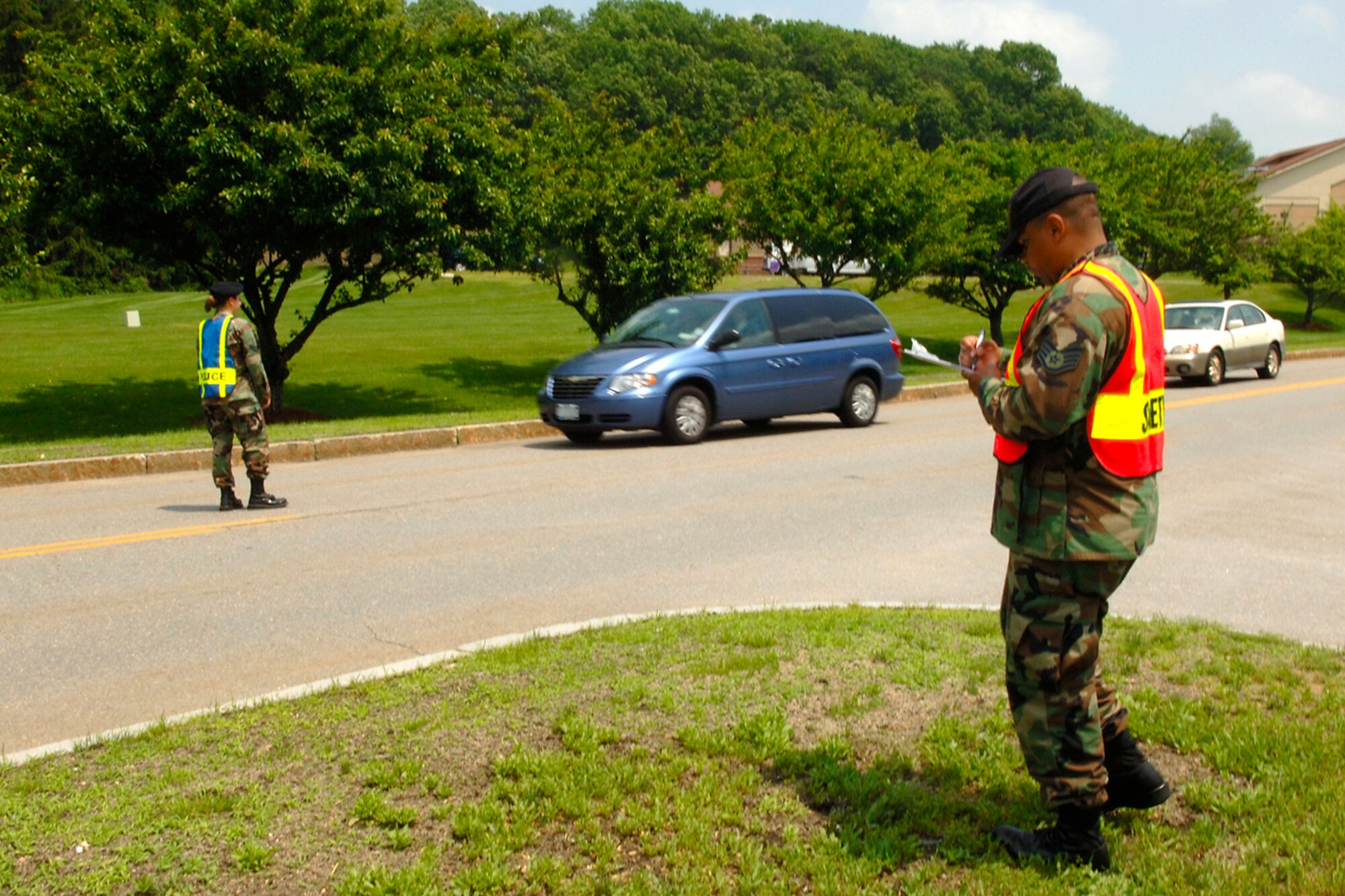 HANSCOM AFB, Mass., -- Members of the 66th Security Forces Squadron check base drivers’ safety belt usage during a ‘Click it or Ticket’ event during June. During the check, four base motorists were cited for not wearing safety belts. Drivers are reminded to wear safety belts and not talk on their cell phones while driving. (U.S. Air Force photo by Jan Abate)