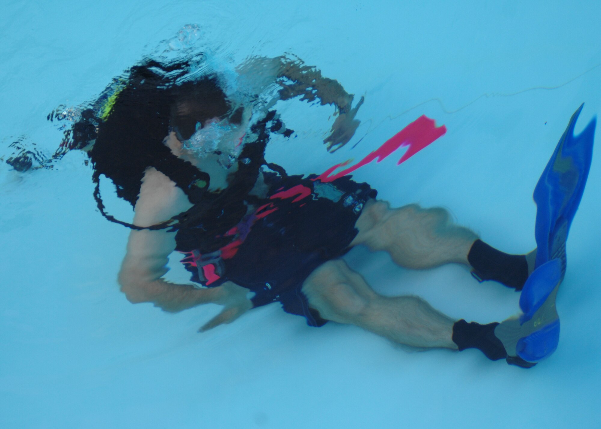 SEYMOUR JOHNSON AIR FORCE BASE, N.C. - A student in the open water SCUBA ceritfication course sits on the bottom of the pool during his first dive, July 25. During the 7-day course participants learn fundamentals of scuba diving, including dive equipment and techniques. (U.S. Air Force photo by Airman 1st Class Greg Biondo)