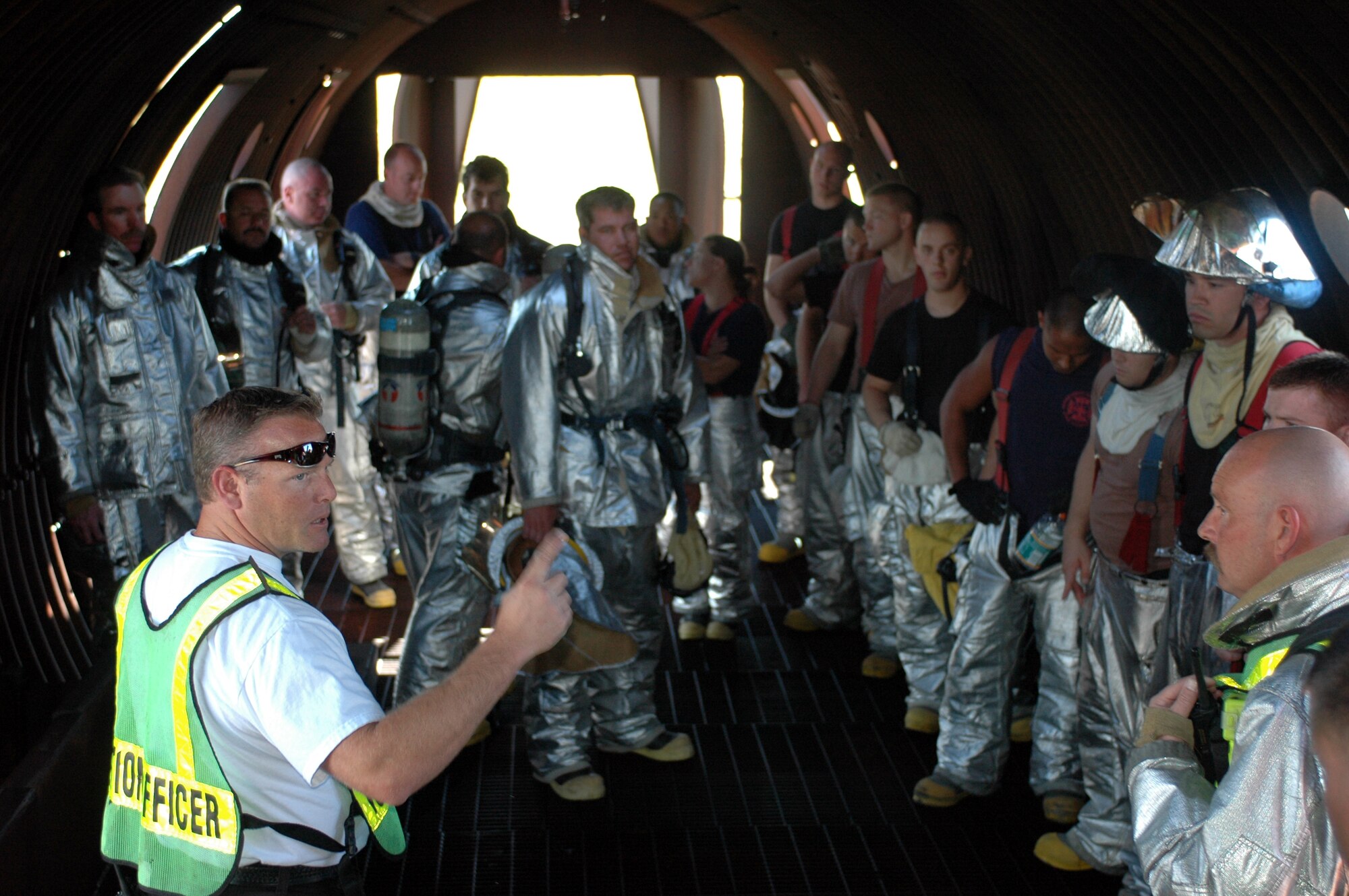 Donald Richert, assistant fire chief, briefs training procedures and safety precautions inside the aircraft mock-up before firefighters begin the training. Travis firefighters train on the mock-up quarterly and the NASA Ames Research Center firefighters train at least once a year. (U.S. Air Force photo/Staff Sgt. Matthew McGovern)