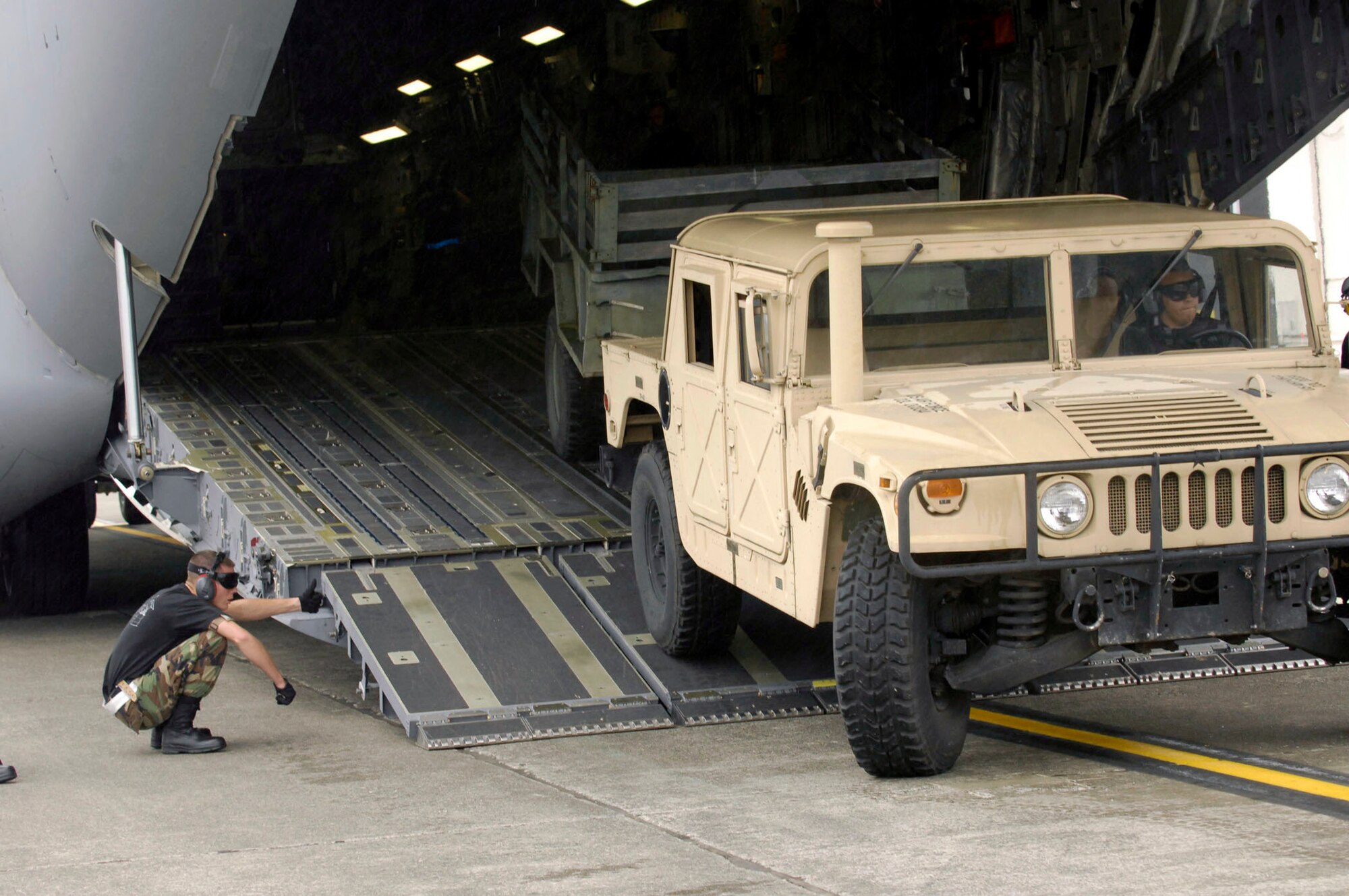 Airmen from the Air Force Reserve Command's 315th Airlft Wing at Charleston Air Force Base, S.C., load a C-17 Globemaster III during the aerial ports engine running on loads competition at Air Mobility Command's Rodeo 2007 July 20 at McChord Air Force Base, Wash. Rodeo 2007 is a readiness competition of U.S. and international mobility air forces. It focuses on improving warfighting capabilities in support of the war on terrorism. (U.S. Air Force photo/Airman 1st Class Nichelle Griffiths)
