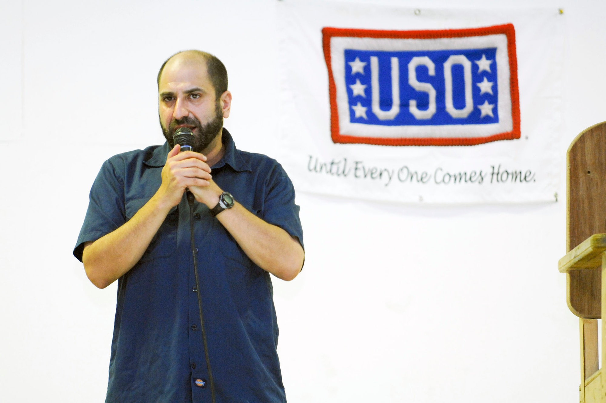Dave Attell performs his comedy routine for more than 700 Soldiers and Airmen during a USO show July 25 at Camp Adder, Iraq. Mr. Attell is traveling with fellow comedian Scott Kennedy. This was the second of eight tour stops in theater. Mr. Attel is star of Comedy Central's "Insomniac with Dave Attell." (U.S. Air Force photo/Master Sgt. Robert W. Valenca) 
