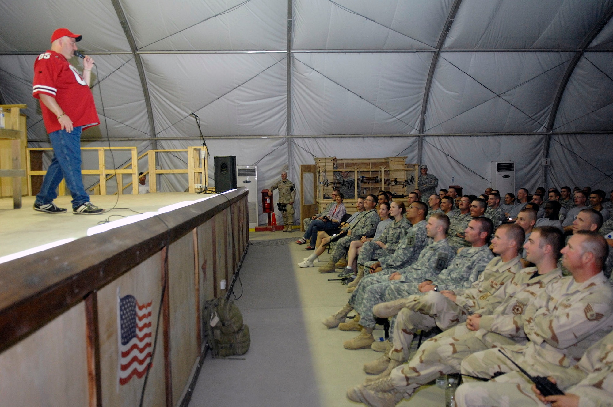 Scott Kennedy performs his comedy routine for more than 700 Airmen and Soldiers at a USO show July 25 at Camp Adder, Iraq. This is Mr. Kennedy's fifth USO tour in the region. He is touring with Dave Attell of Comedy Central's "Insomniac with Dave Attell." Camp Adder was the second of eight stops in theater. (U.S. Air Force photo/Master Sgt. Robert W. Valenca)
