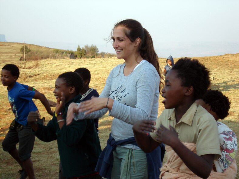 Senior Airman Van Pelt learns a new game with Mavis, one of the children she befriended, on top of the mountain in Leratong. (Courtesy Photo)  