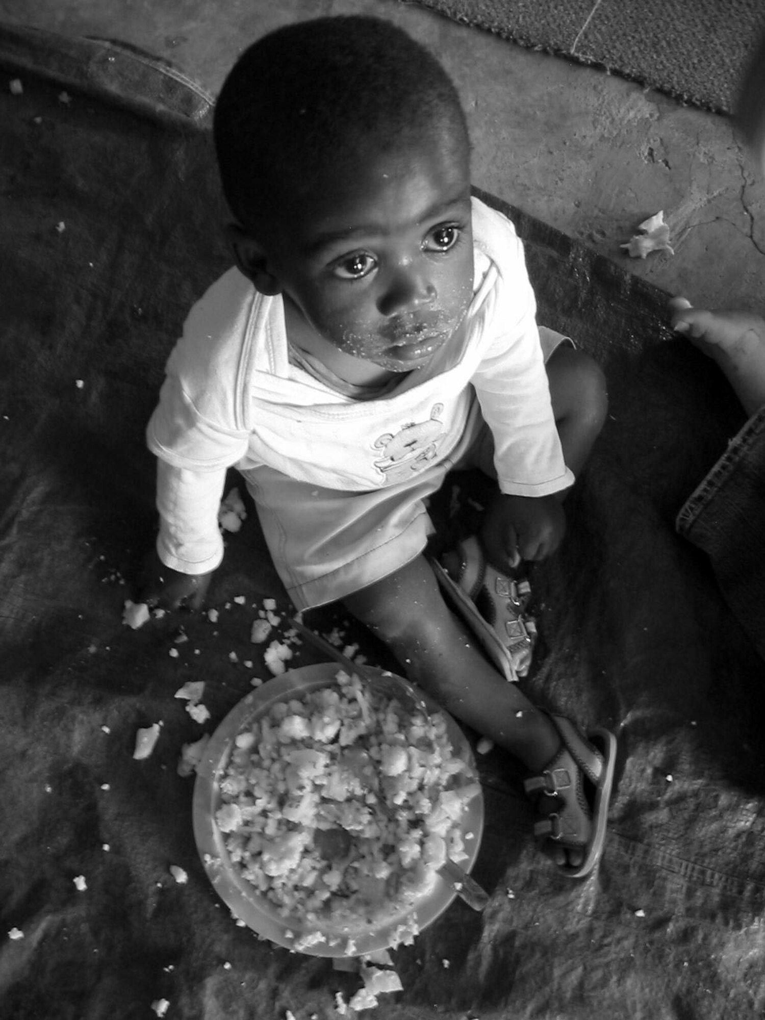 A child from the village of Leratong in Qwa Qwa, South Africa eats “maize pap" -- a simple corn meal dish -- for breakfast at the Breakthrough Ministries dayecare. 
Senior Airmen Genifer Van Pelt, Senior Airman Jessica Koury and Leah Kossakoski and Amanda Mellos, who have both since separated from the Air Force, went to the ministry located in South Africa to volunteer for two weeks in September 2006. (Courtesy Photo)