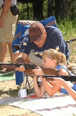 Master Sgt. Dale Gunter, 120th Security Forces Squadron unit training manager, instructs Little Warrior Sarah, 12, on how to properly fire a B.B. gun during Operation Purple Camp. The camp is designed for children with deployed parents to help them learn about and cope with their parent’s deployment. (U.S. Air Force photo / Airman 1st Class Dillon White)