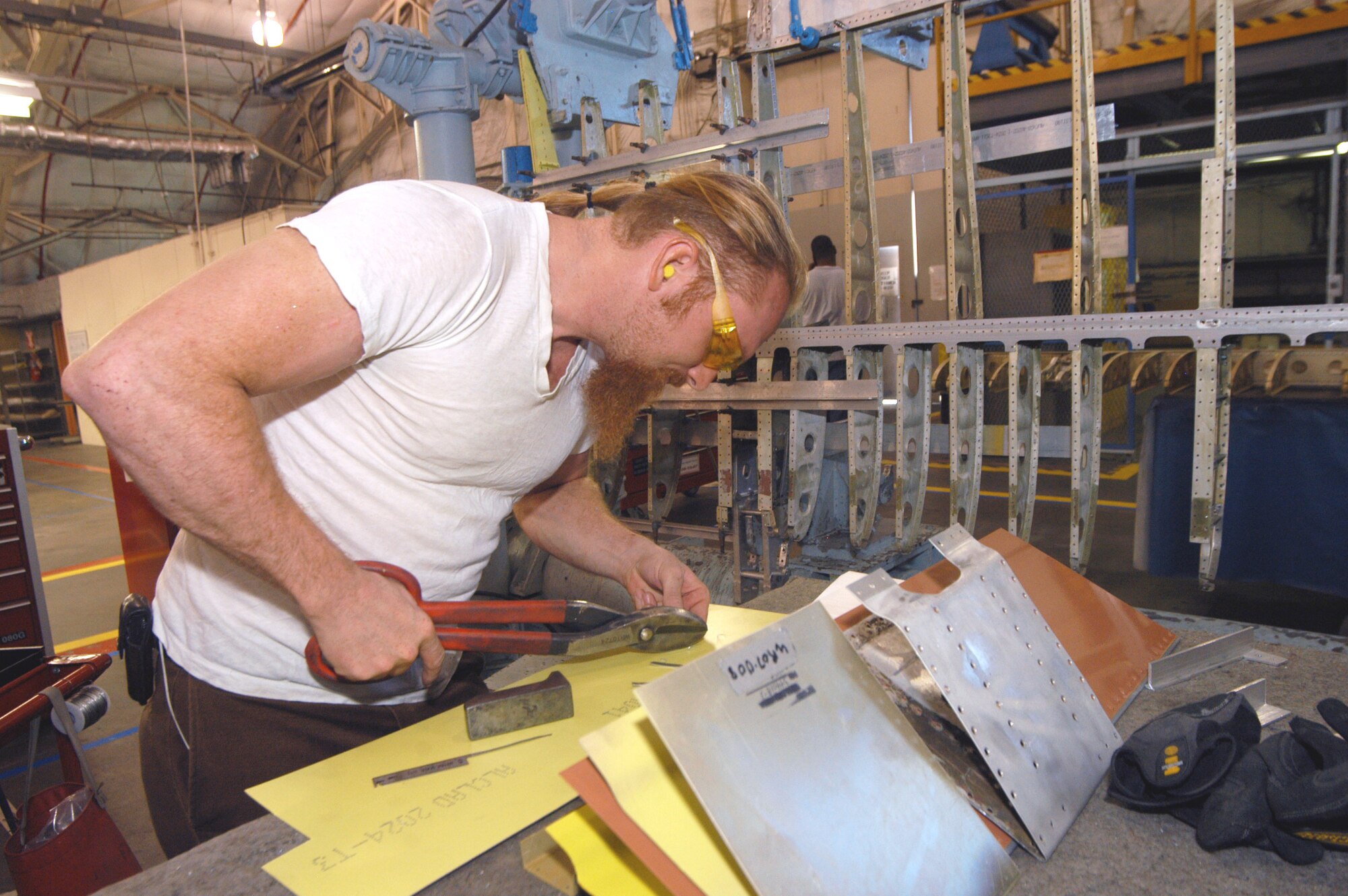 Steve Foote, makes a repair to correct a rivet hole size. U. S. Air Force photo by Sue Sapp  