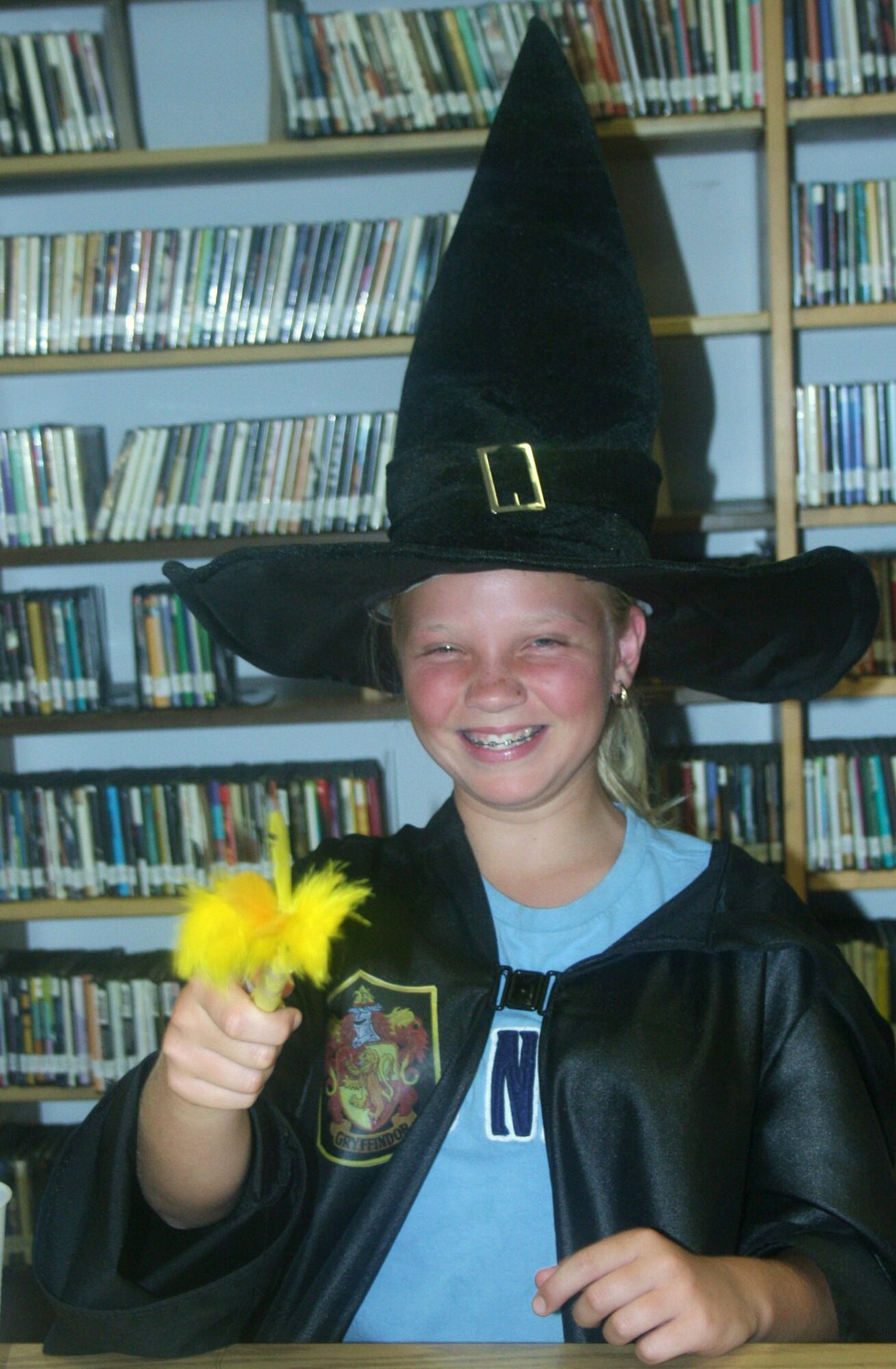 Courtney Rampel, 12,  casts a spell with her newly create ‘magic wand’ during Harry Potter night July 20 in the Aviano Library.  (Photo by Hugh C. McBride)