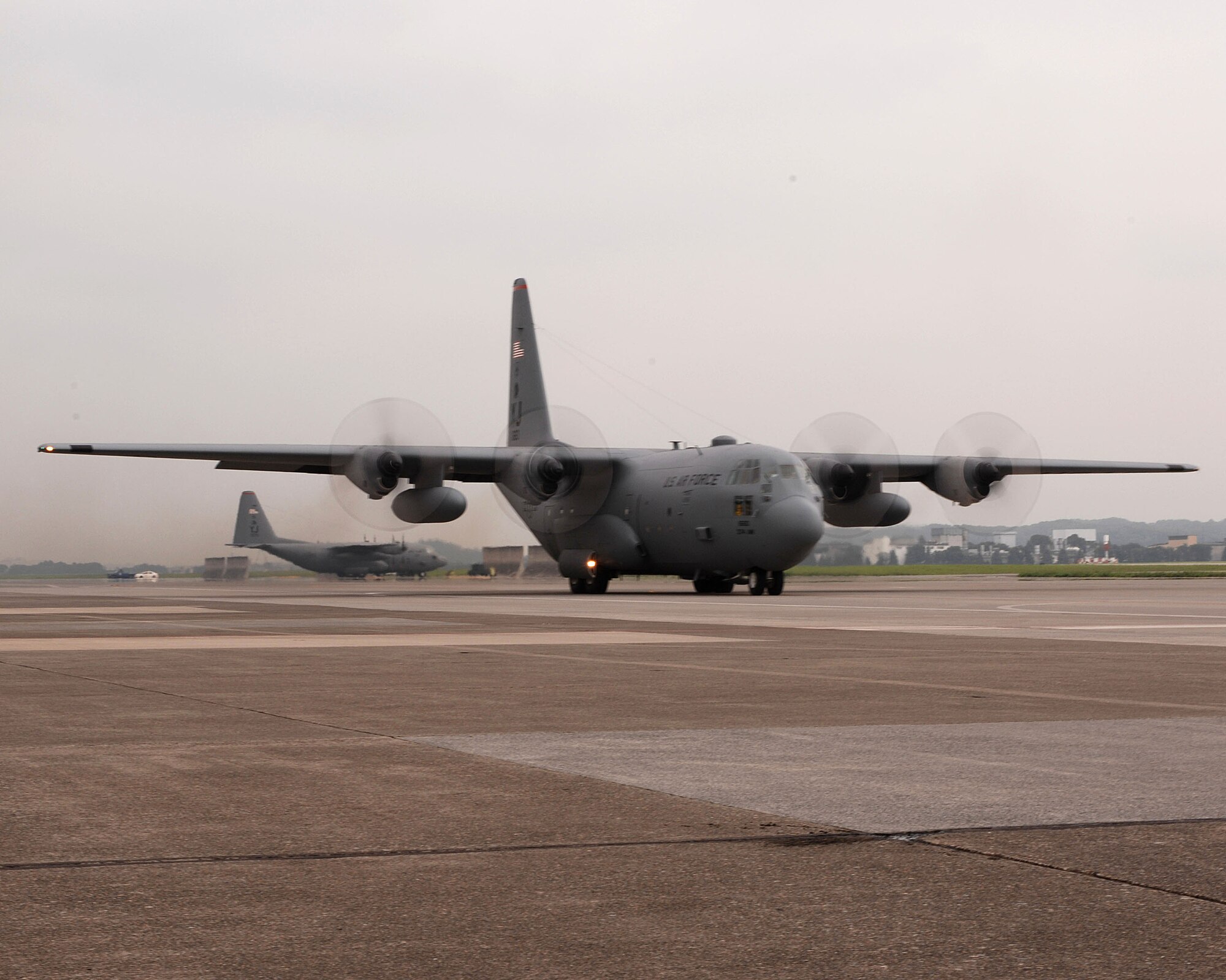 A C-130 Hercules assigned to the 36th Airlift Squadron, taxis for take off after recieving not one, but two black letter initials prior to take off, July 20 and 21, thanks to the Airmen of the 374th Aircraft Maintenance Squadron (AMXS) and the aircraft depot yard in Singapore.(U.S. Air Force Photo by A1C Laszlo Babocsi)(Released)