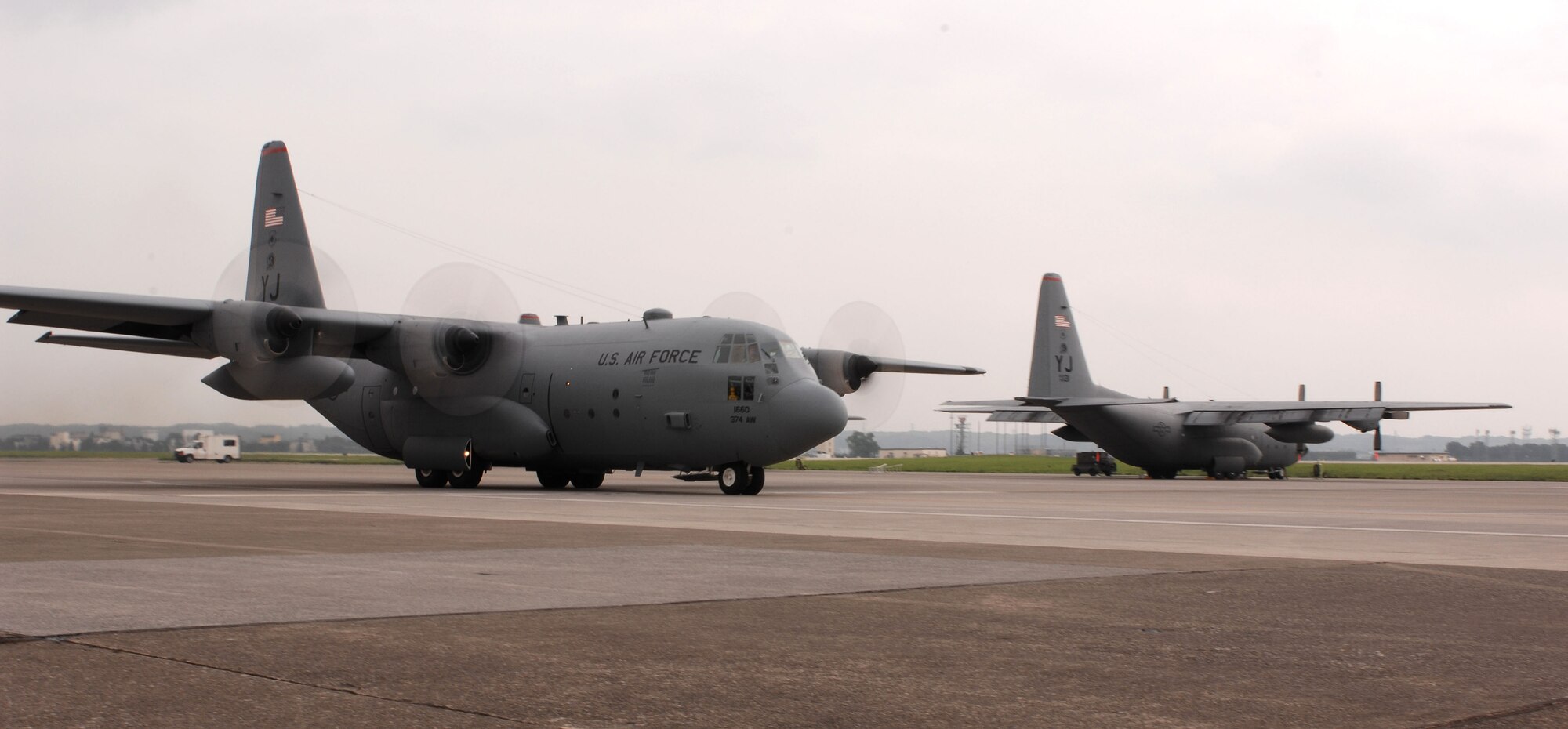 A C-130 Hercules assigned to the 36th Airlift Squadron taxis for take off after recieving not one, but two black letter initials prior to take off, July 20 and 21, thanks to the Airmen of the 374th Aircraft Maintenance Squadron (AMXS) and the aircraft depot yard in Singapore.(U.S. Air Force Photo by A1C Laszlo Babocsi)(Released)