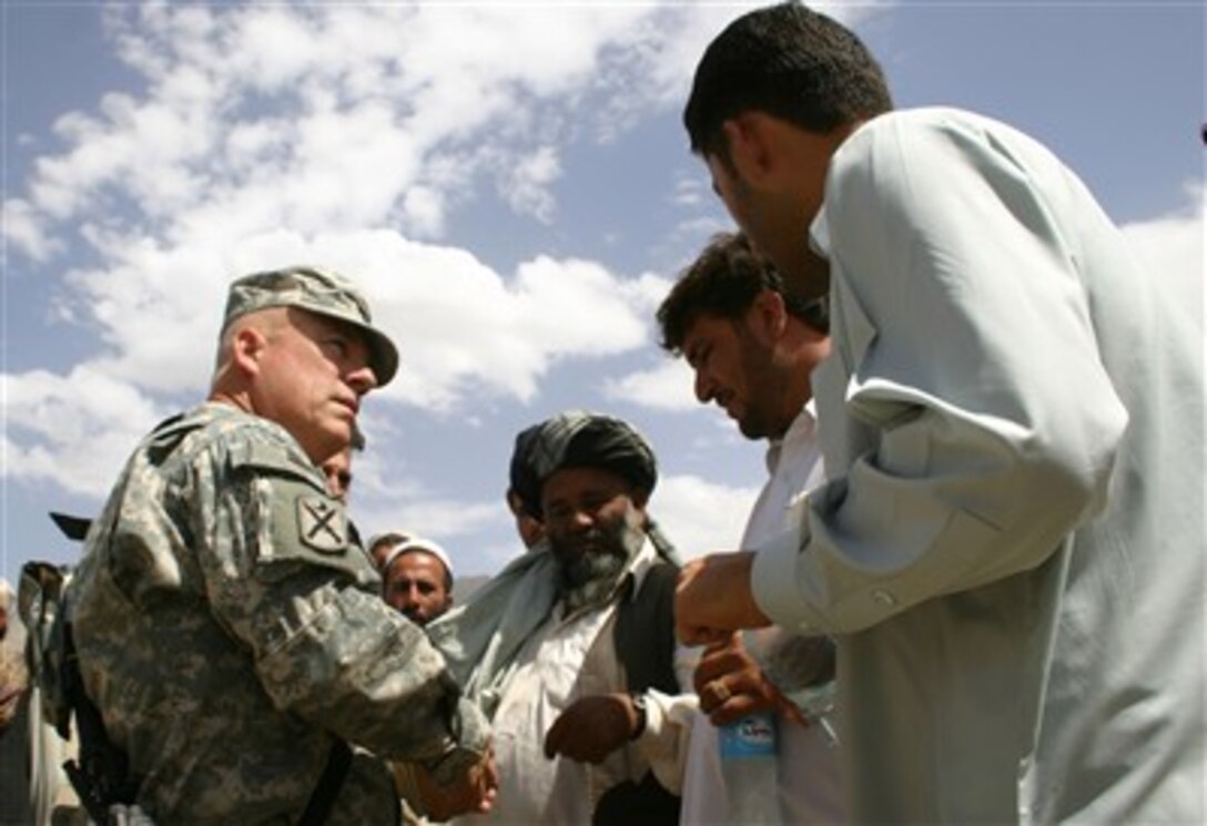 Lt. Col. Chuck Murff, civil military affairs officer, coordinates humanitarian assistance with Kuchi camp elders near Bagrami, Afghanistan. Task Force Phoenix is building a relationship with the Kuchi community. 