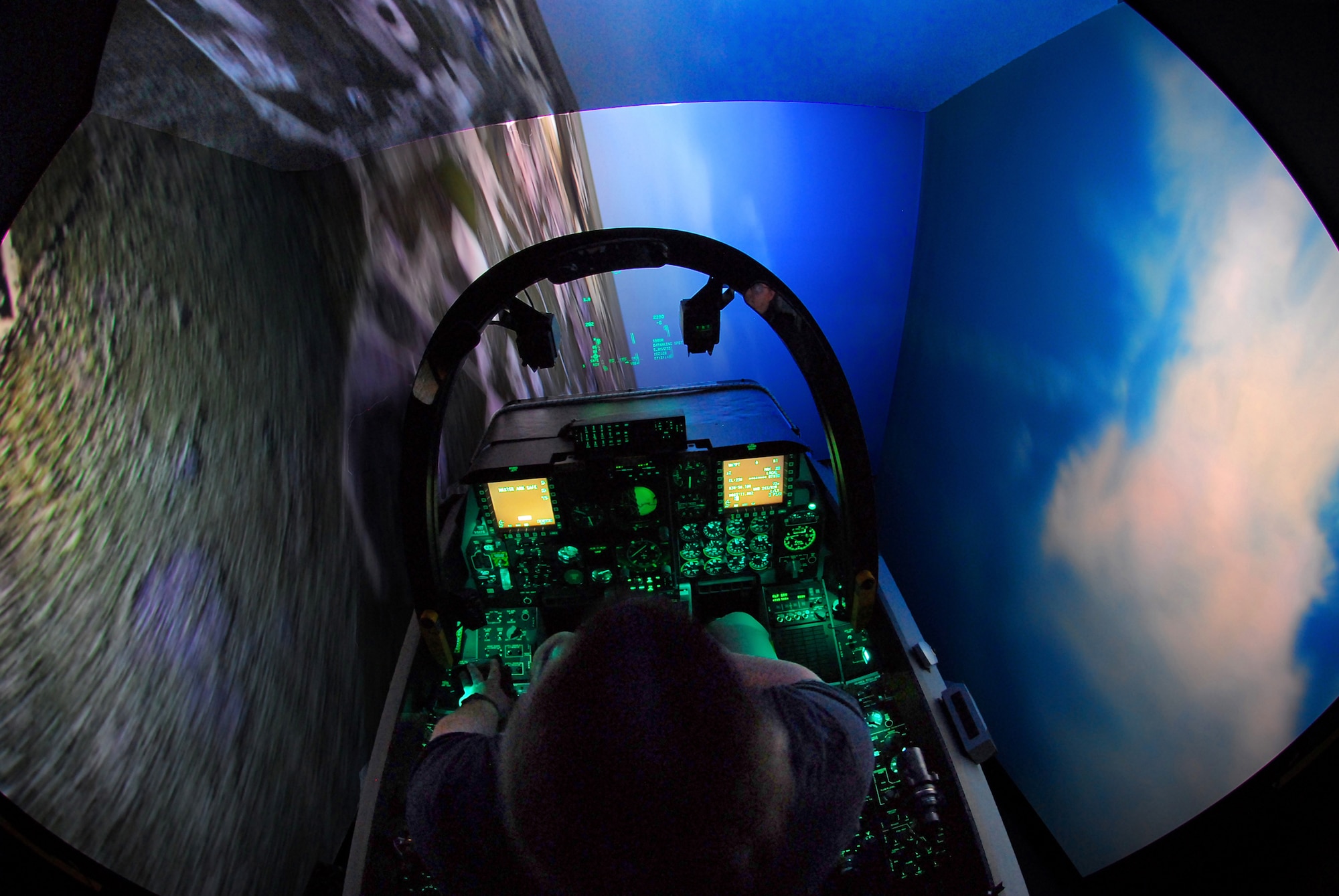 Steven Callich, A-10C Full Mission Trainer instructor, banks the FMT in a hard turn over a virtual Moody Air Force Base, Ga., July 27. The $3.2 million simulator is designed to exactly mimic the appearance and behavior of an upgraded A-10C. It can be linked with other simulators around the world to practice complex tactics.  (U.S. Air Force photo by Tech. Sgt. Parker Gyokeres)