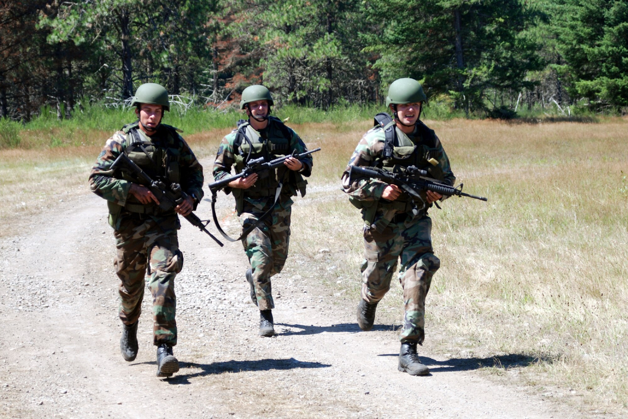 Senior Airman Peter Midura, Tech. Sgt. Chris Wright, and Senior Airman Andrew Prunitis, all 305th Security Forces Squadron Phoenix Ravens from McGuire Air Force Base, N.J., near the finish line during the Security Forces Weapons Event for Air Mobility Rodeo 2007 at McChord AFB, Wash., July 25.  (U.S. Air Force Photo by Airman 1st Class Rebekah Phy)