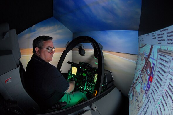 Steven Callich, A-10C Full Mission Trainer instructor, prepares the FMT for a training mission over a virtual Moody Air Force Base, Ga., July 27. The $3.2 million simulator is designed to exactly mimic the appearance and behavior of an upgraded A-10C. It can be linked with other simulators around the world to practice complex tactics.  (U.S. Air Force photo by Tech. Sgt. Parker Gyokeres)