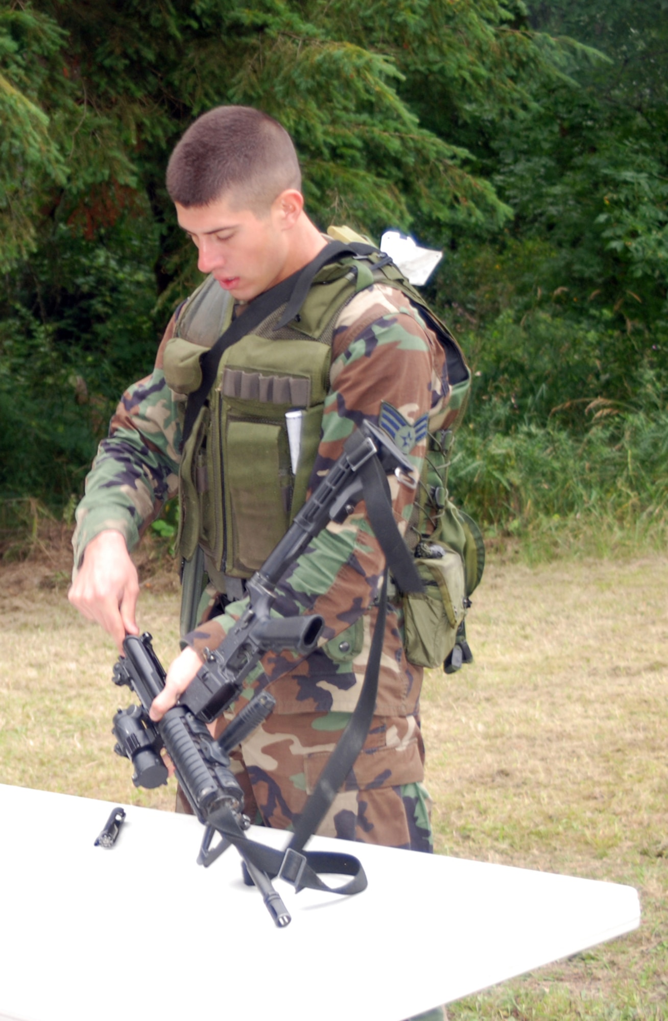 Senior Airman Peter Midura, 305th Security Forces Squadron Phoenix Raven, McGuire Air Force Base, N.J., breaks down an M-4 during the Security Forces Combat Challenge for Rodeo 2007 at McChord AFB, Wash., July 26. Airman Midura was part one of three members representing McGuire's security forces team during the Rodeo competition. Photo by Airman 1st Class Rebekah Phy