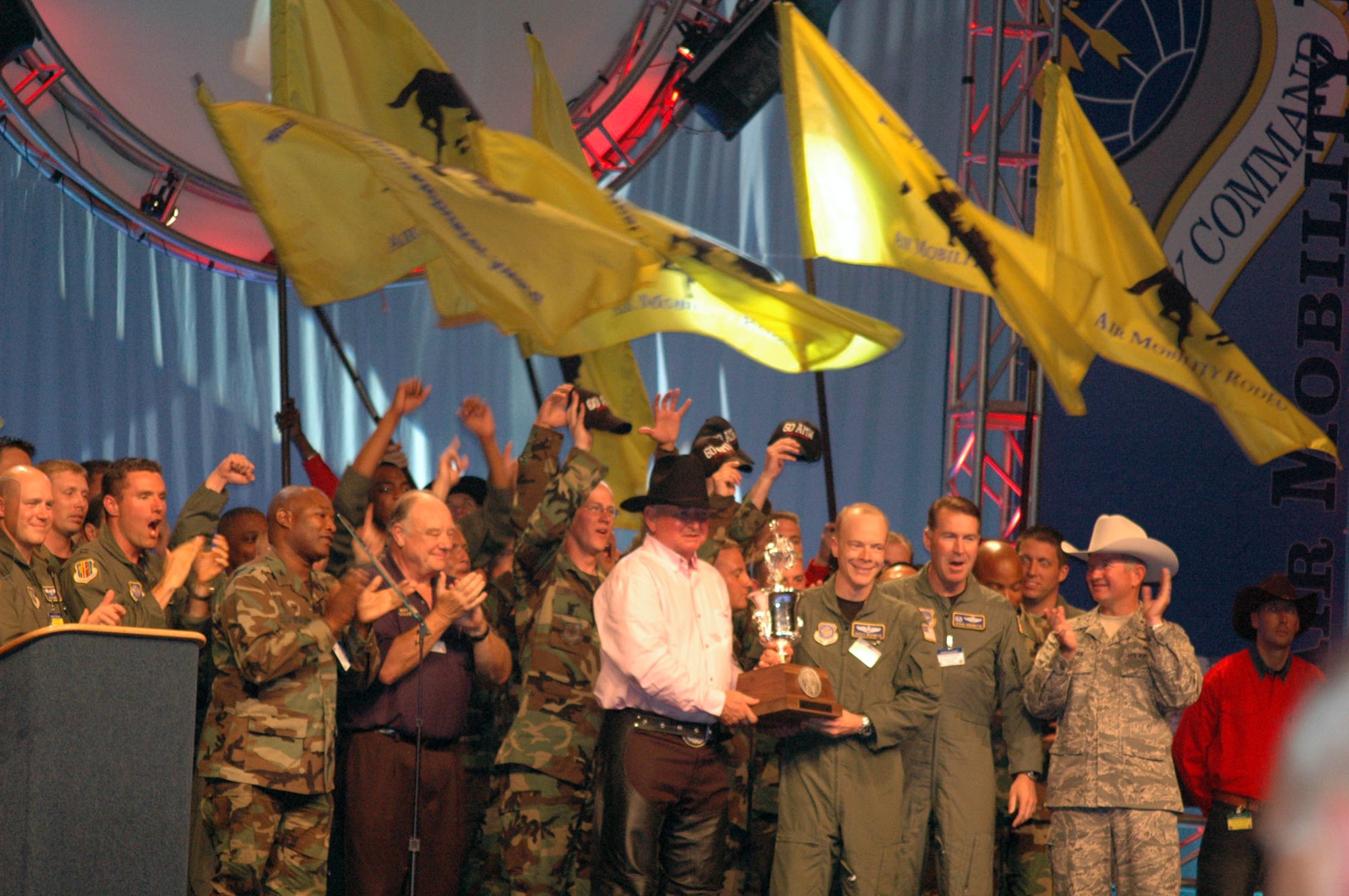 Team members from the 60th Air Mobility Wing, Travis Air Force Base, Calif., celebrate after winning the "Best Air Mobility Team" award at Air Mobility Rodeo 2007 during the closing celebration July 27, 2007.  The award signifies the "best of the best" among all the Rodeo teams.  (U.S. Air Force Photo by Tech. Sgt. Scott T. Sturkol)