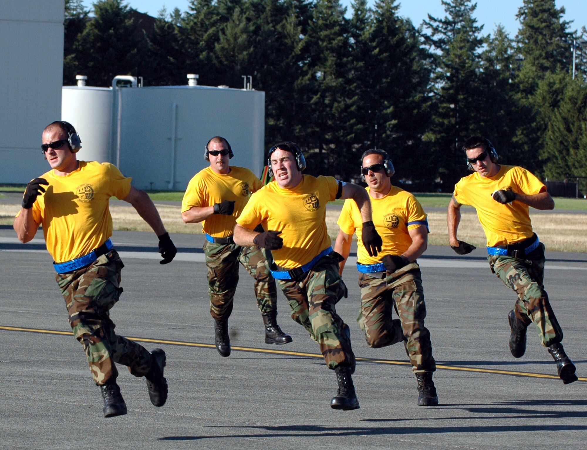 The 60th Aerial Port Squadron Rodeo team makes a mad dash to the finish line after successfully loading a hummer and K-loader into a C-5 Galaxy. Once back at the finish line the team prepared to unload the vehicles in the shortest time possible without any mistakes. (U.S. Air Force photo/Airman 1st Class Kristen Rohrer)