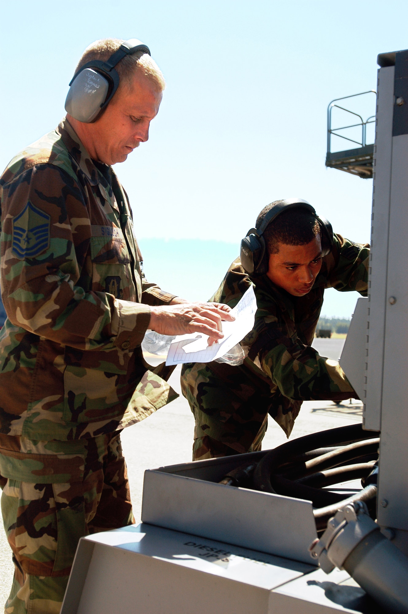 Master Sgt. Paul Sigloch, 514th Air Mobility Wing aircraft overhaul supervisor, and Senior Airman Arjuna Ramcharan, 305th Air Mobility Wing C-17 crew chief, inspect a A/N32-86 diesel generator set, which supplies elecrical power to their C-17 Globemaster III at Air Mobility Rodeo 2007 at McChord Air Force Base, Wash. The two are part of a blended team from McGuire Air Force Base, N.J., made up of both Air Force active-duty and reserve personnel, at the Air Mobility Rodeo 2007. Both McGuire AFB and Charleston AFB, S.C., sent blended teams to Rodeo.  Rodeo 2007 is a readiness competition of U.S. and international mobility air forces. It focuses on improving warfighting capabilities and support of the Global War on Terrorism. (U.S. Air Force photo/Staff Sgt. Mark R. W. Orders-Woempner)
