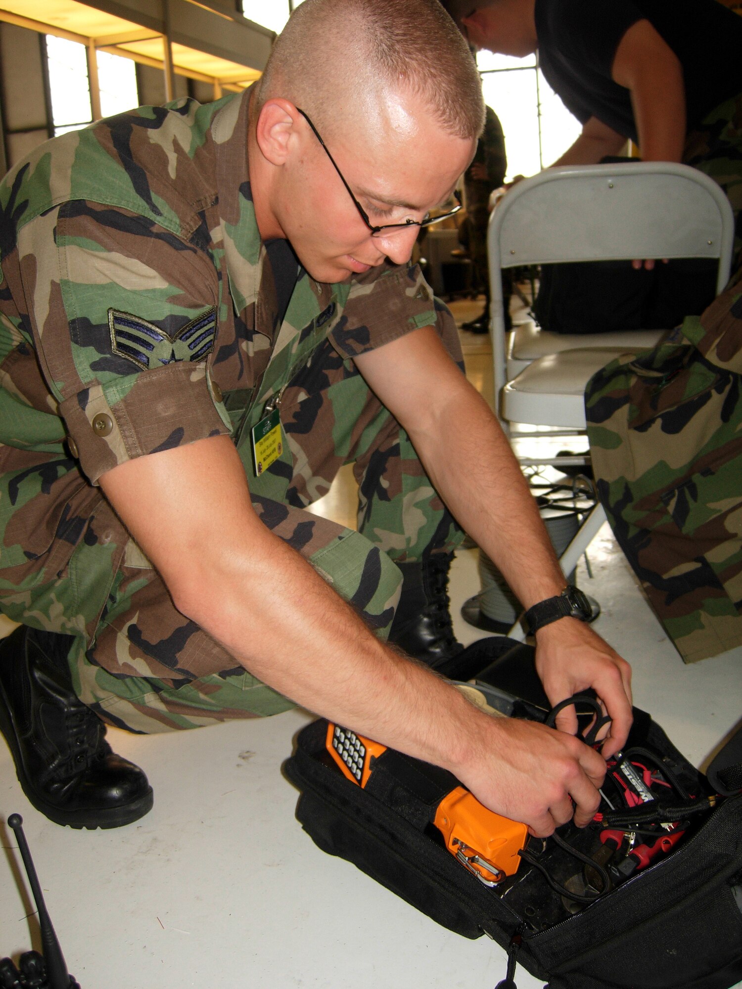 Senior Airman William Powell, 62nd Communications Squadron voice network systems specialist, replaces his tools after installing a new telephone line at the Rodeo Communications Team in processing line July 26 at McChord Air Force Base, Wash. Rodeo, sponsored by Air Mobility Command, is a readiness competition between U.S. and international mobility air forces. (U.S. Air Force photo/Staff Sgt. Amaani Lyle)  