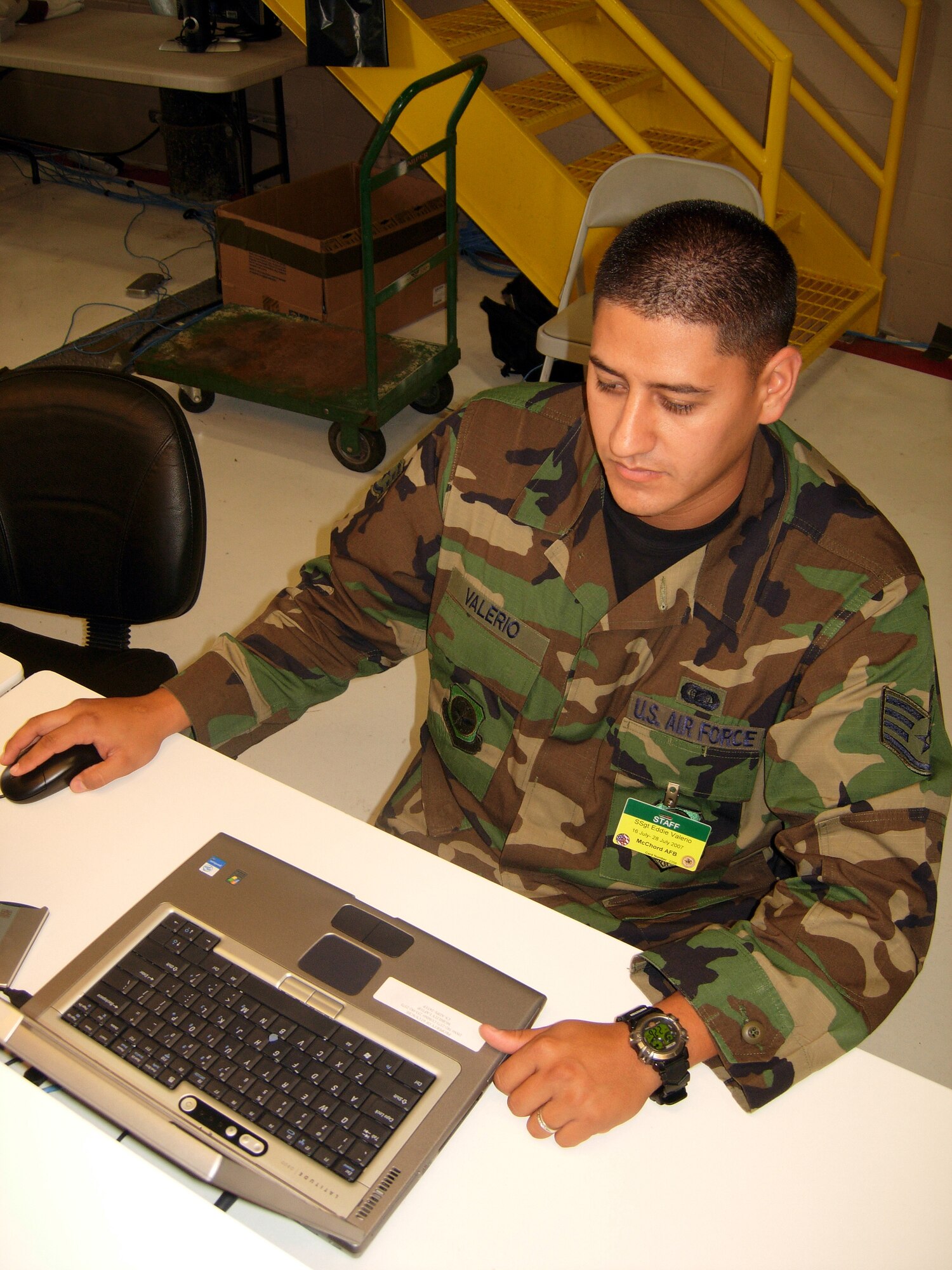 Staff Sgt. Eddie Valerio, 62nd Communications Squadron information manager, uses a personnel program to input data during Air Mobility Rodeo 2007 at McChord Air Force Base, Wash., July 26. Rodeo, sponsored by Air Mobility Command, is a readiness competition between U.S. and international mobility air forces. (U.S. Air Force photo/Staff Sgt. Amaani Lyle) (Released)   