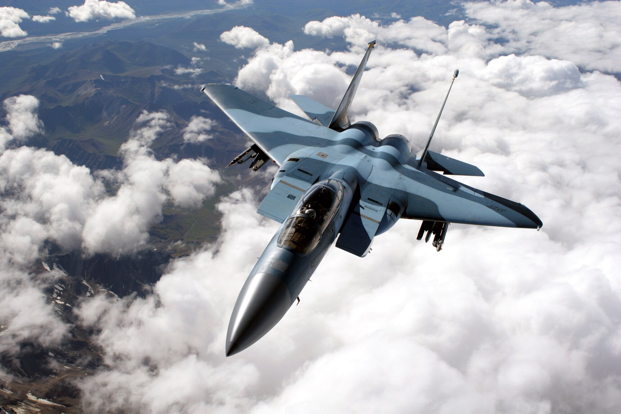An F-15C Aggressor from the 65th Aggressor Squadron at Nellis Air Force Base, Nev., flies over a mountain range on a refueling mission at Red Flag-Alaska July 25. Red Flag-Alaska enables aviation units to sharpen their combat skills by flying simulated combat sorties in a realistic threat environment. More than 80 aircraft and 1,500 servicemembers from six countries are participating in the exercise July 12 to 27. (U.S. Air Force photo/Capt. Tana Stevenson)