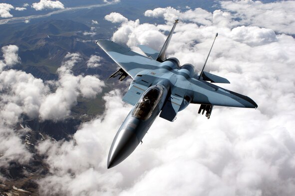 An F-15C Aggressor from the 65th Aggressor Squadron at Nellis Air Force Base, Nev., flies over a mountain range on a refueling mission at Red Flag-Alaska July 25. Red Flag-Alaska enables aviation units to sharpen their combat skills by flying simulated combat sorties in a realistic threat environment. More than 80 aircraft and 1,500 servicemembers from six countries are participating in the exercise. (U.S. Air Force photo/Capt. Tana Stevenson) 