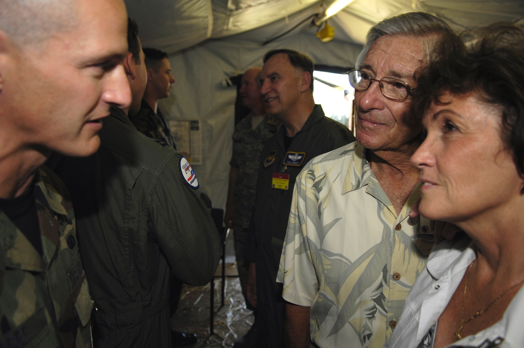 Retired Air Force Maj. Joe Lodrige, and his wife Lila, talk with an Airman at the Air Mobility Rodeo 2007 Purple Heart recognition reception at McChord Air Force Base, Wash., July 26.  Major Lodrige and his crew with the 1502nd Air Transport Wing from Hickam AFB, Hawaii, won the first active-duty Rodeo competition in 1962. Rodeo 2007 is a readiness competition of U.S. and international air mobility forces.  It focuses on improving war fighting capabilities and support of the Global War on Terrorism. (U.S. Air Force photo/Airman 1st Class Cole Presley) 

