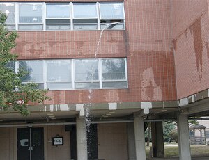 316th Civil Engineer Squadron firefighters route water out from the third floor of the 316th Wing headquarters building after a 4-inch chilled water return line from the heating, ventilation and air conditioning system burst, gushing water for several hours. Some sections of the third-floor were covered by water.