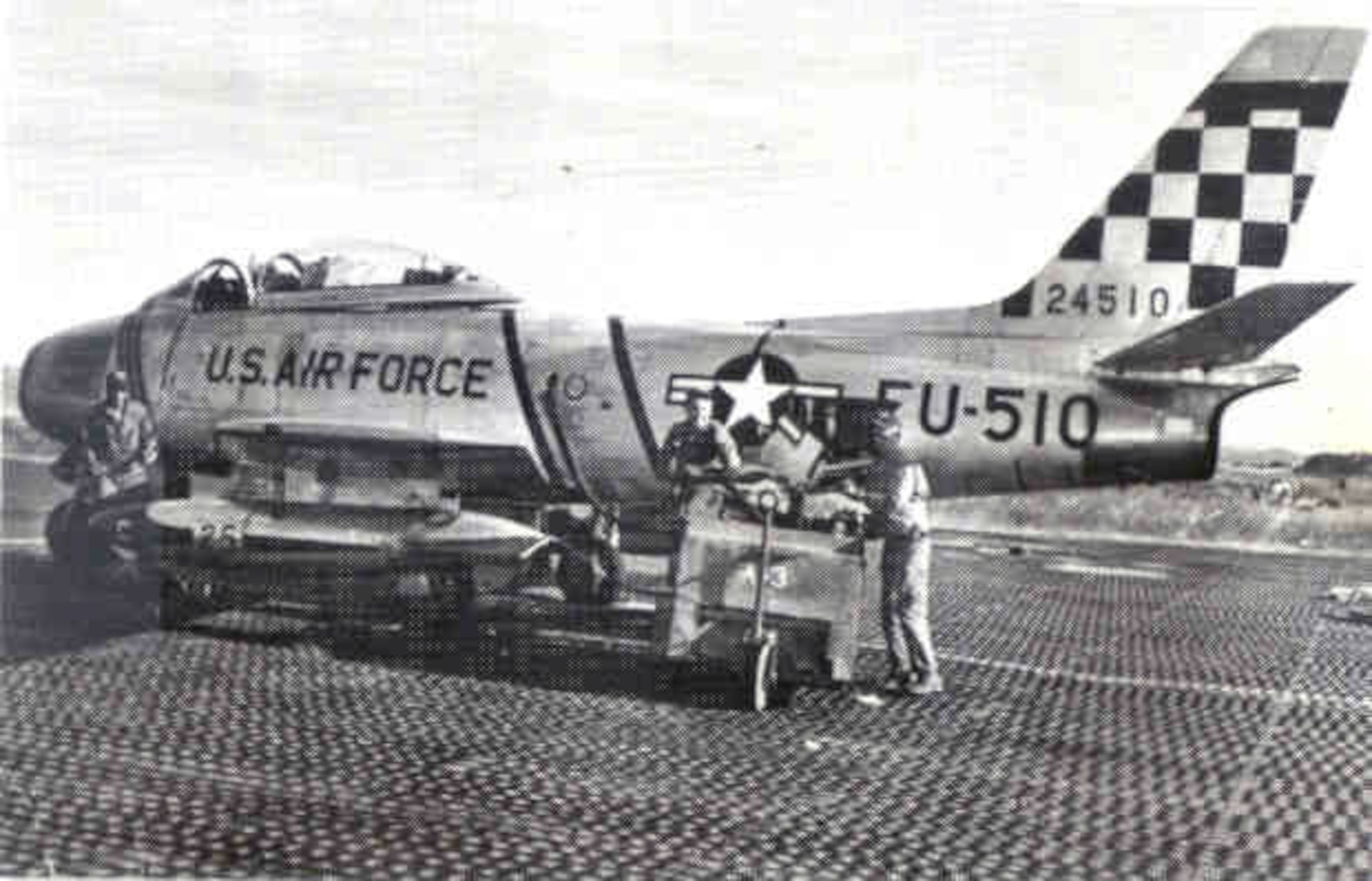 Ground crews prepare an F-86 Sabre with its 51st Fighter Interceptor  Wing  "Checkertail" for flight during the Korean War.  (Courtesy photo)