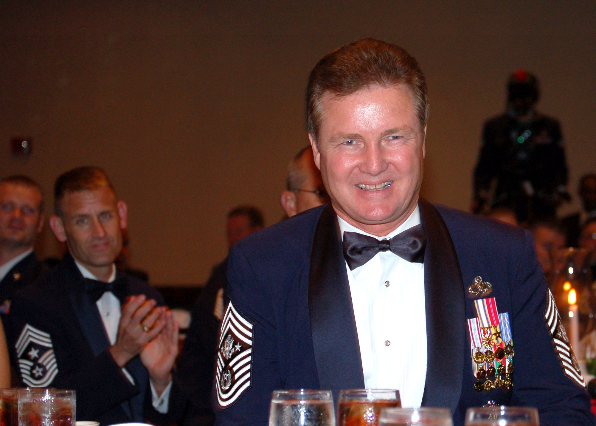 Fourteenth Chief Master Sgt. of the Air Force Gerald Murray is introduced to the more than 650 people in attendance for the Senior Enlisted Leaders Conference Heritage Dinner July 26 in Montgomery, Ala. The event was a celebration of the Air Force's 60th Anniversary and the 40th Anniversary of the inception of the office of the chief master sergeant of the Air Force. (U.S. Air Force photo/Master Sgt. Lee Roberts) 
